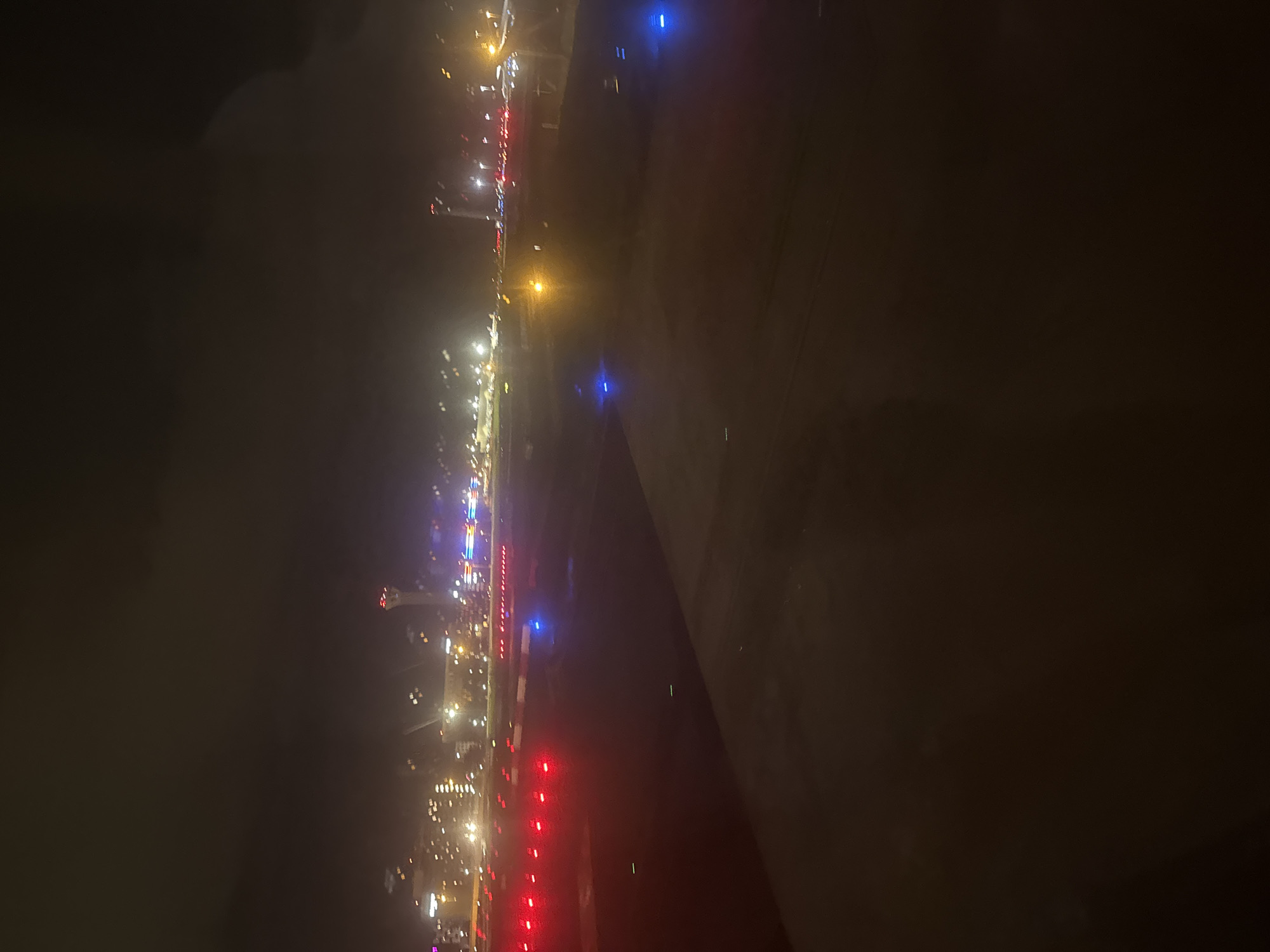 Nighttime aerial view of illuminated airport from airplane window