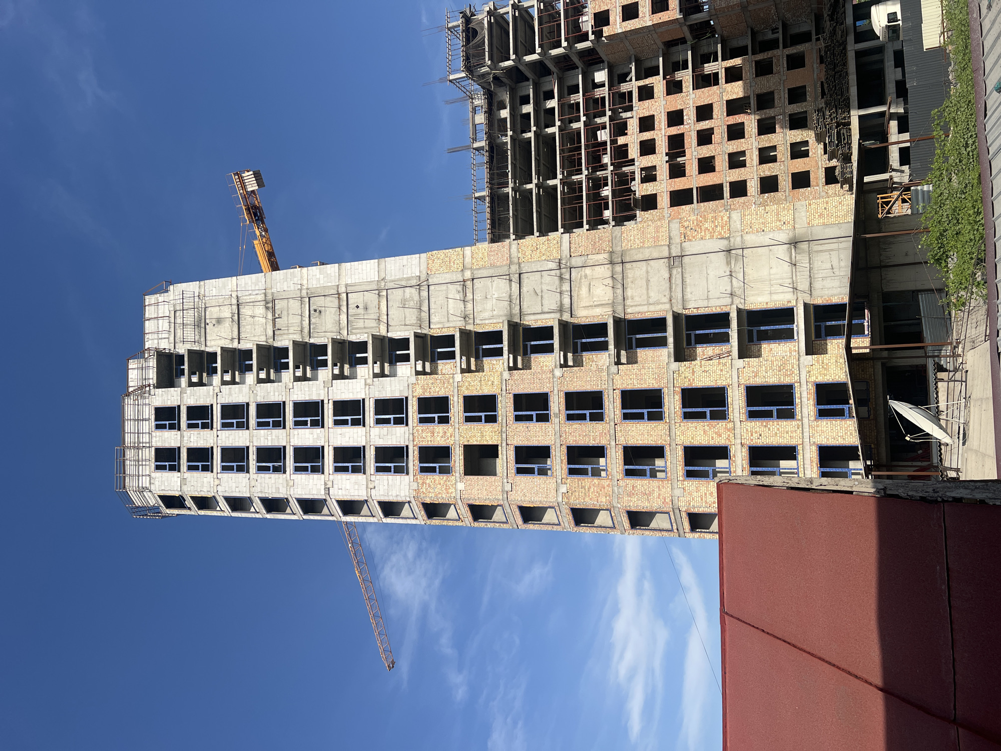 Construction underway in Lebedinovka, cranes and unfinished buildings