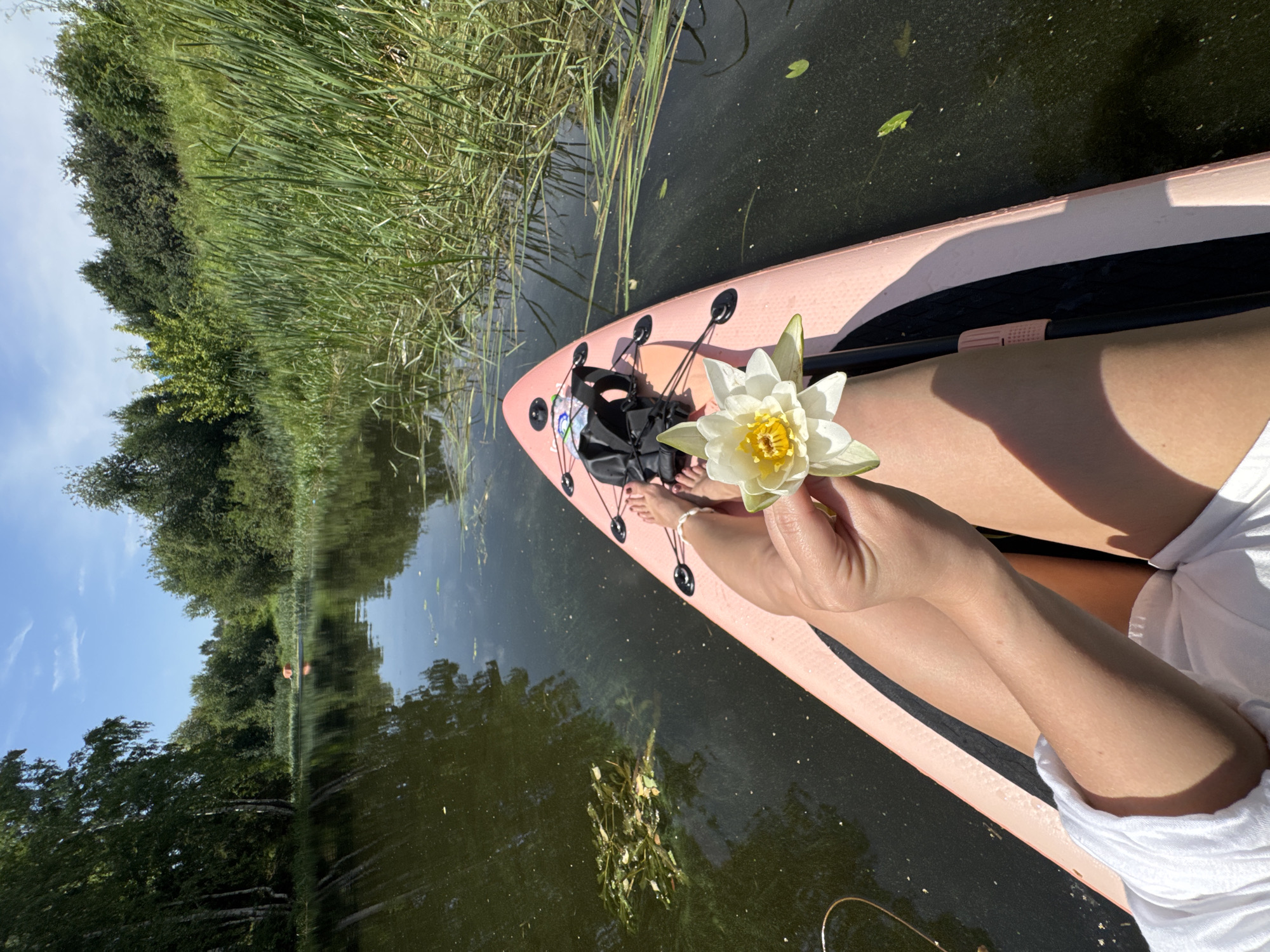 Paddleboarding a quiet, reed-lined river in rural Russia