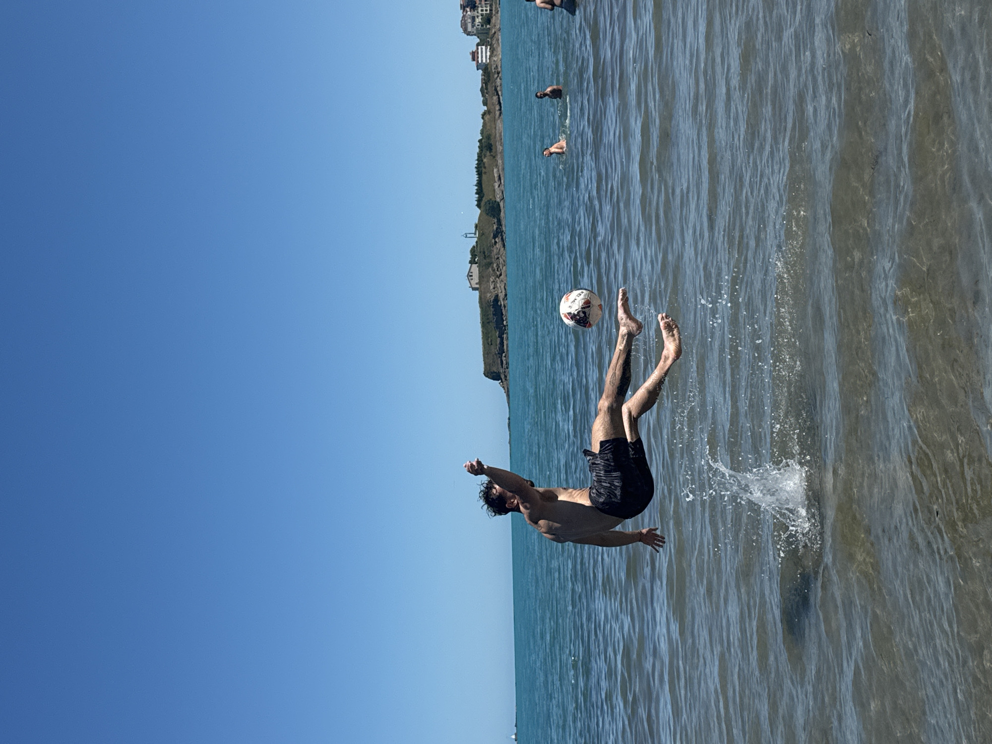 Man plays soccer in shallow waters off Tsarevo coast