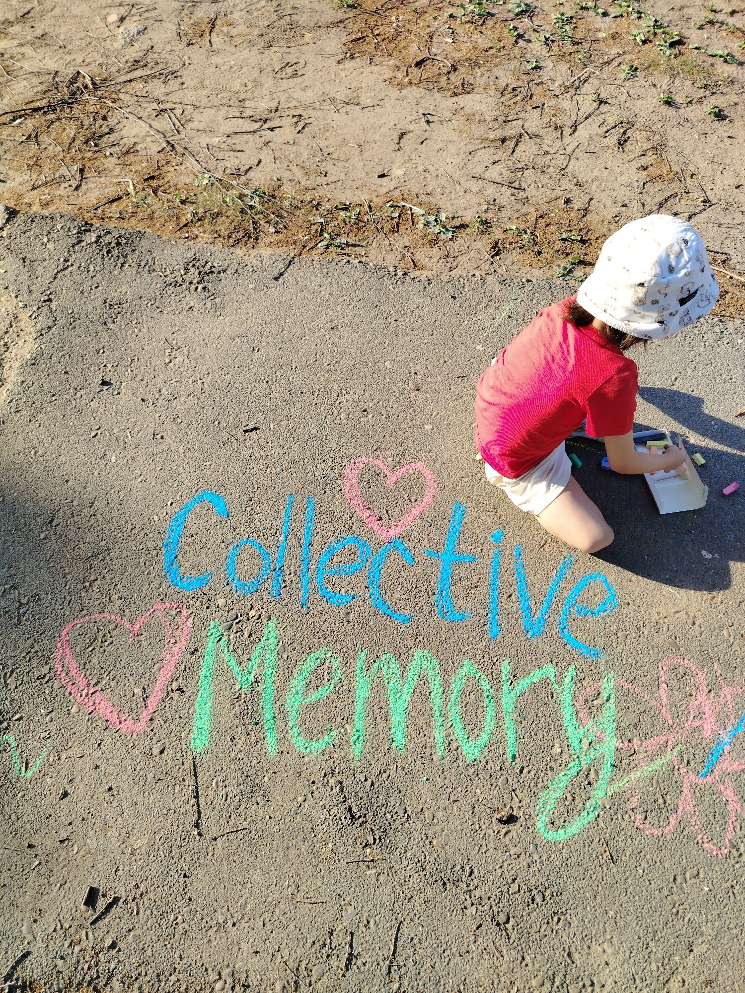 Woman and child create chalk art in Noviy, Russia