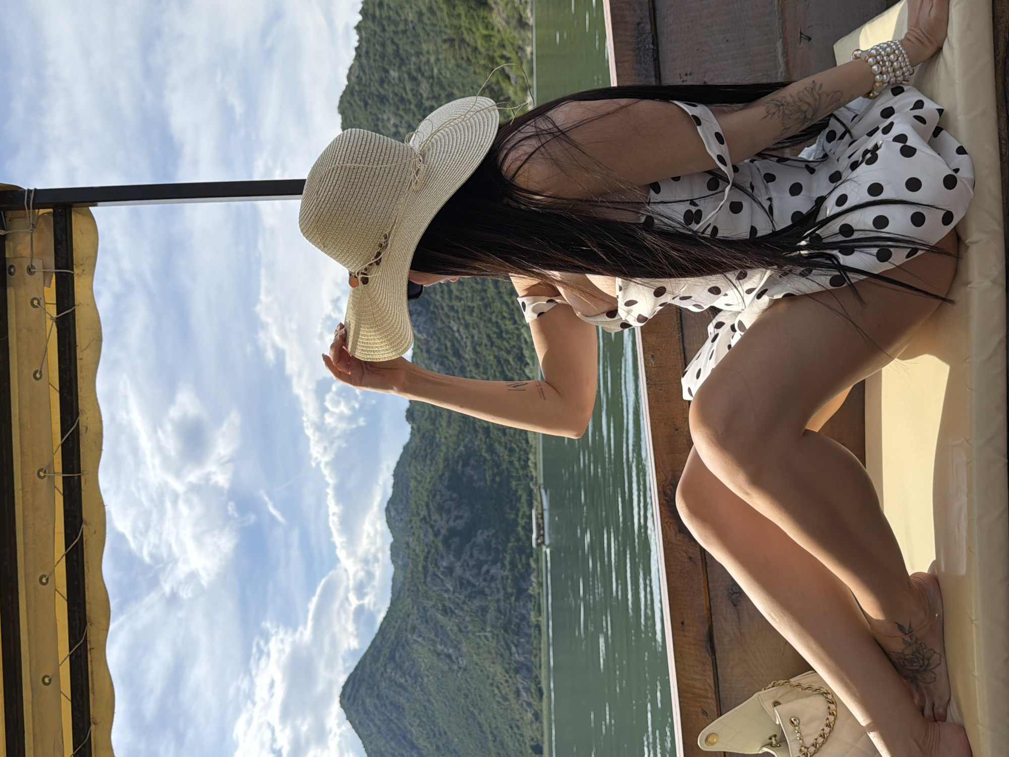 Woman in polka dot dress enjoys boat trip in Montenegro