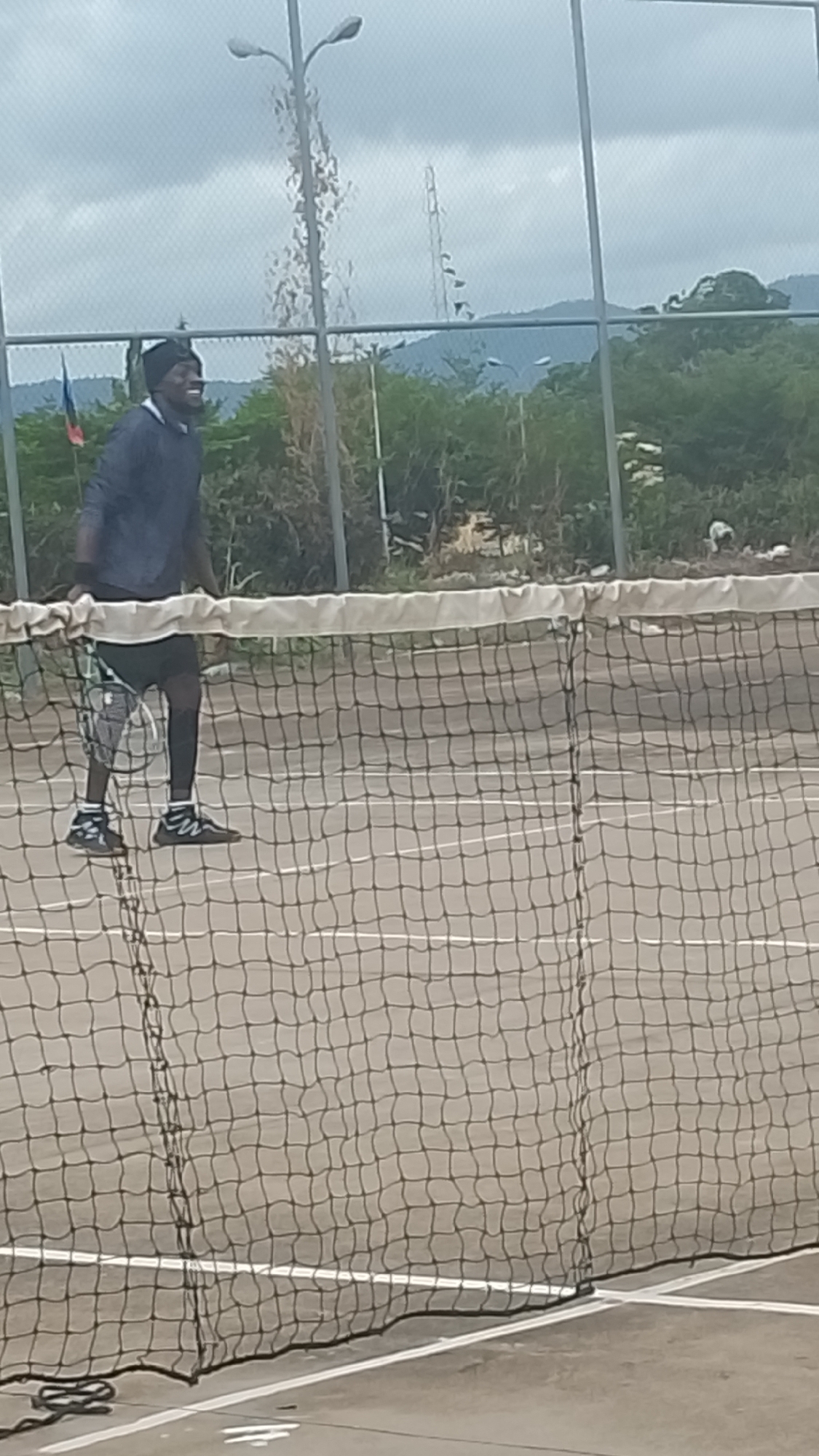 Tennis players active on outdoor courts in Lokoja, Nigeria