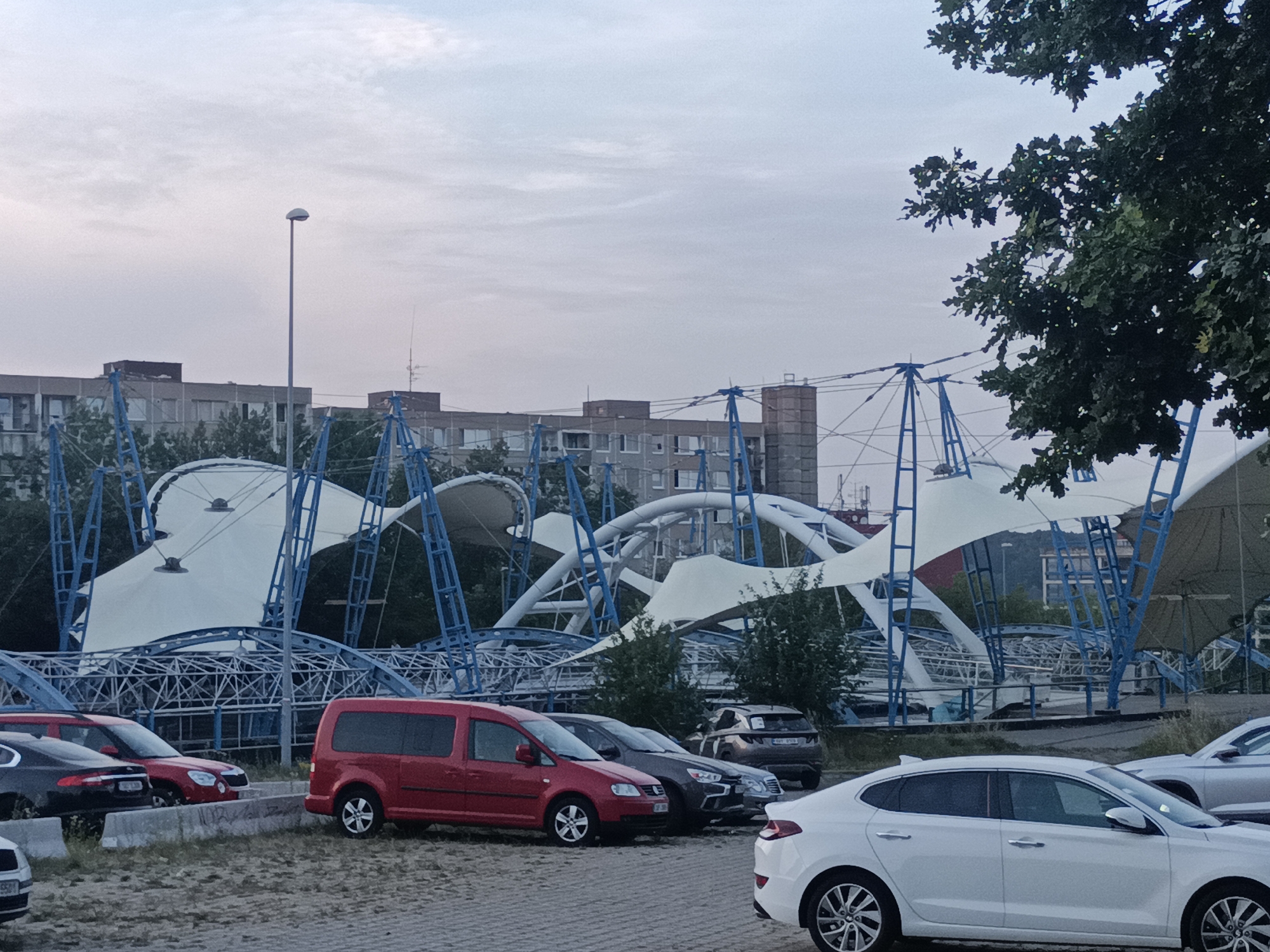 Evening transit loop through Prague, ending at a tent-roof venue