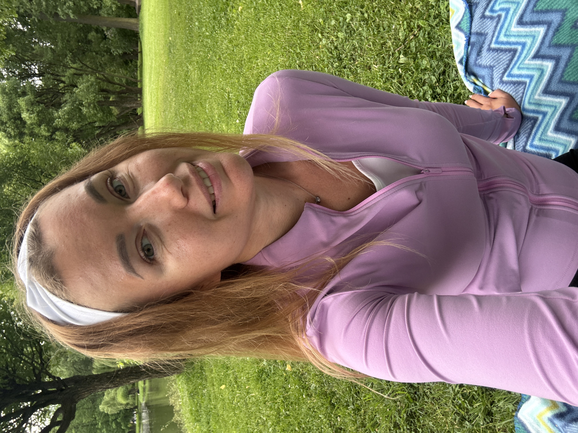 Woman spends afternoon picnicking and relaxing in lakeside park