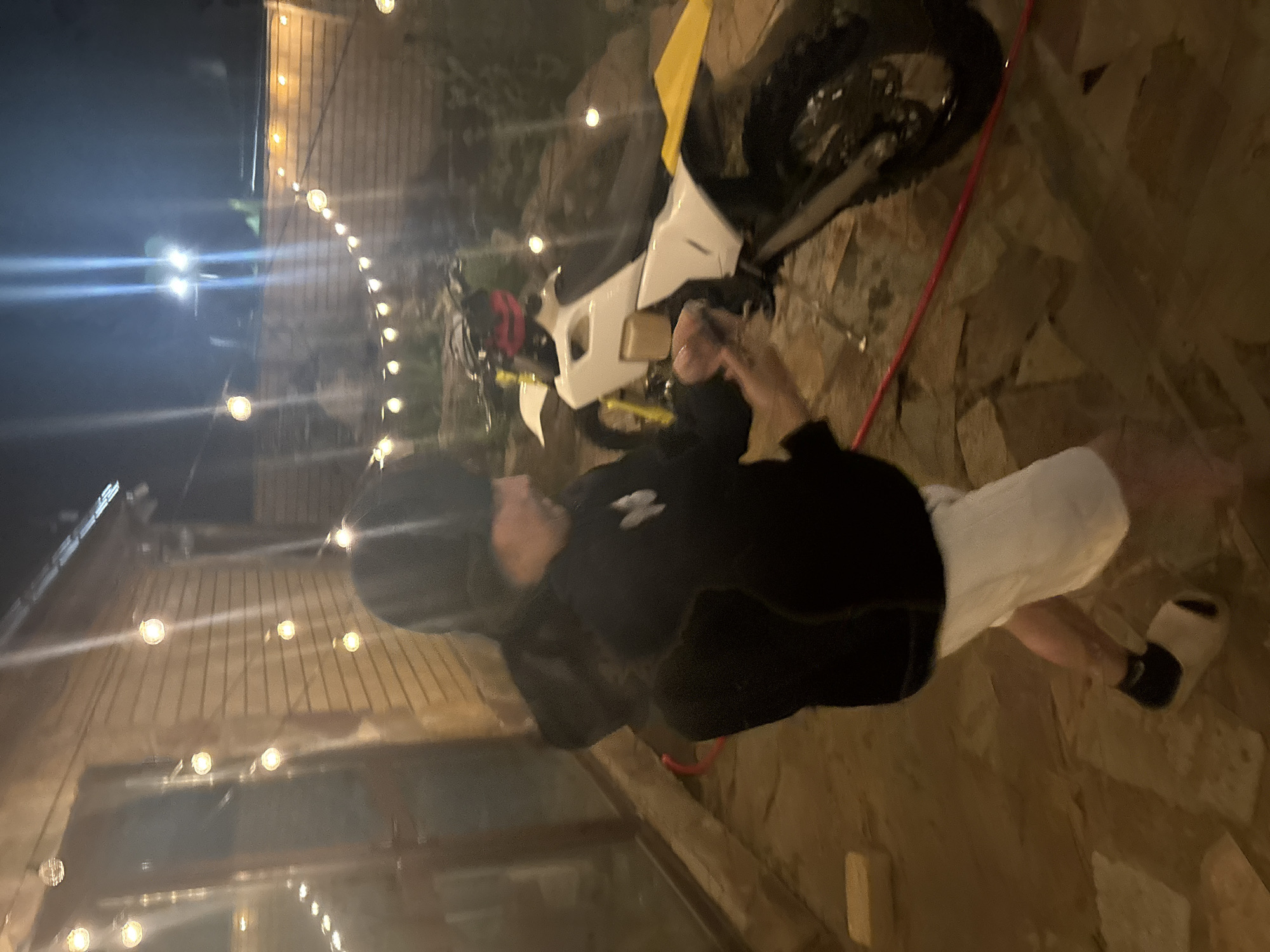 Man poses with dirt bike during nighttime gathering in Russia