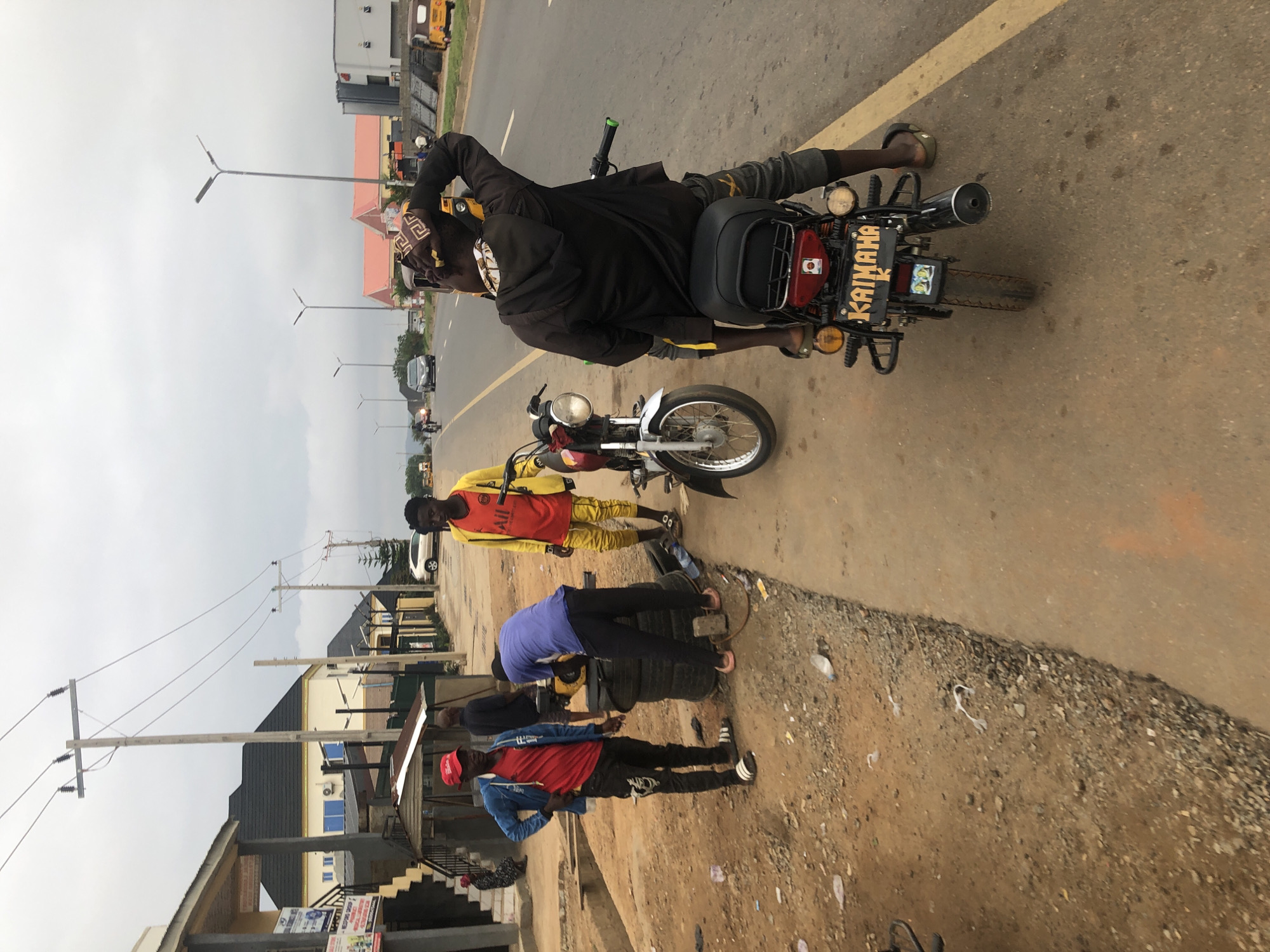 Morning street gathering observed in Abuja with motorcycles, tricycle