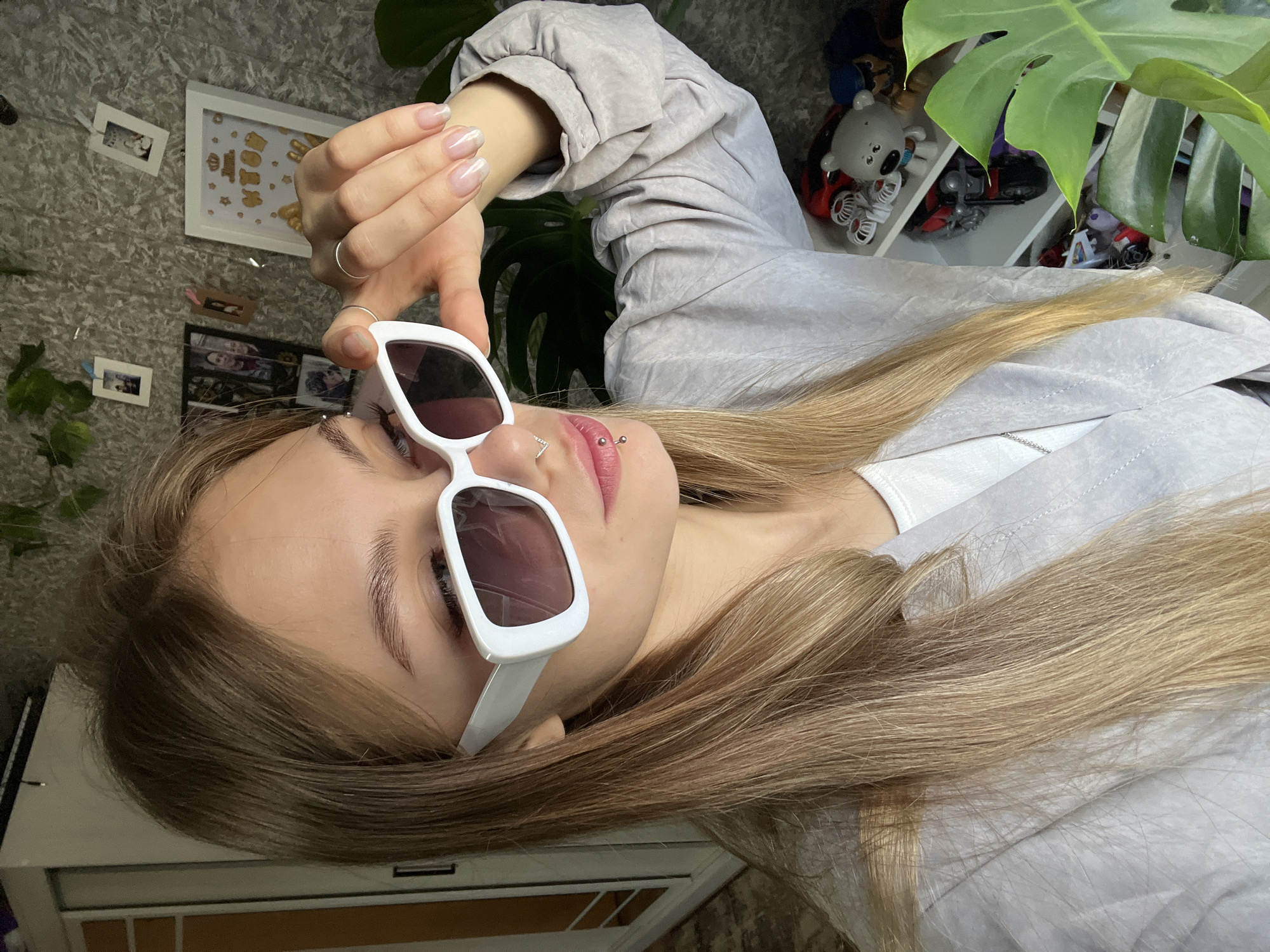 Woman with piercings rests with sunglasses in Foki, Russia