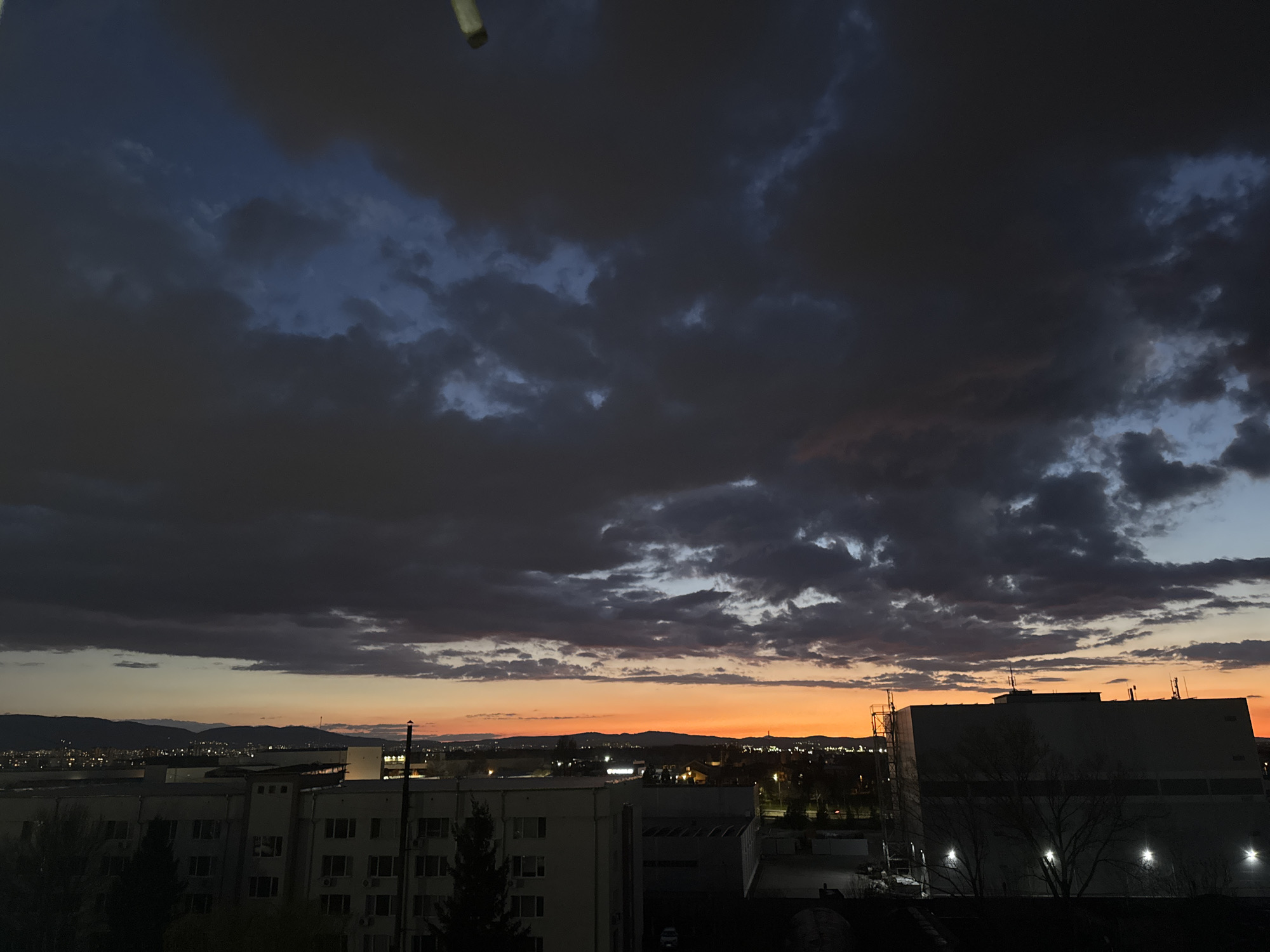 Dramatic storm clouds gather over Sofia at dusk