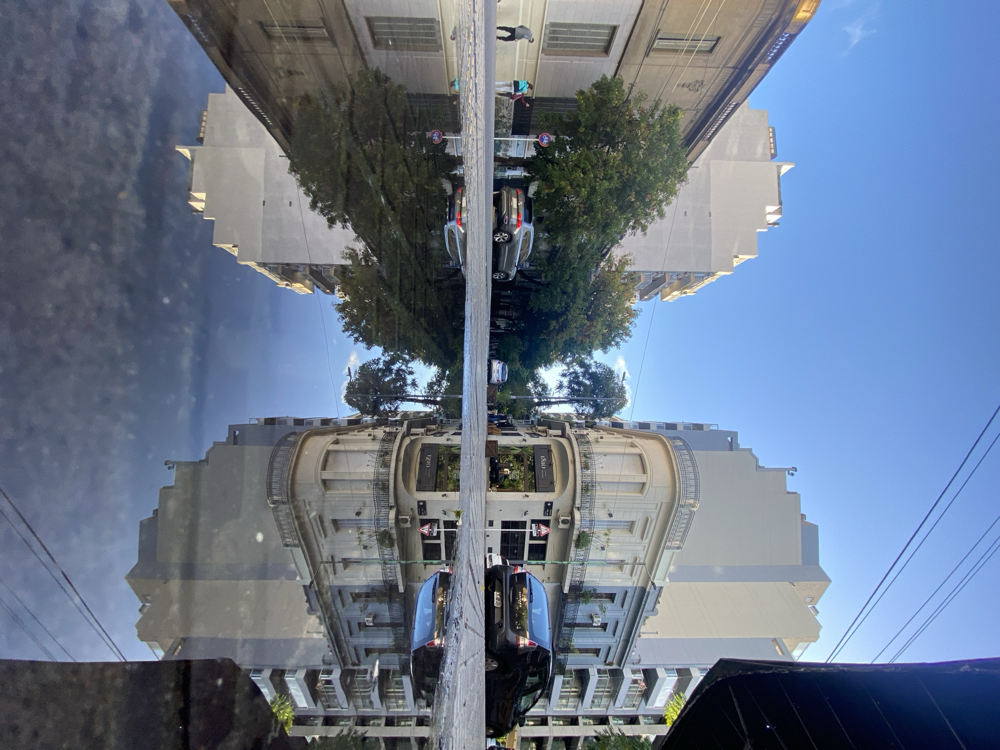 Street reflection creates symmetrical mirror scene in Buenos Aires