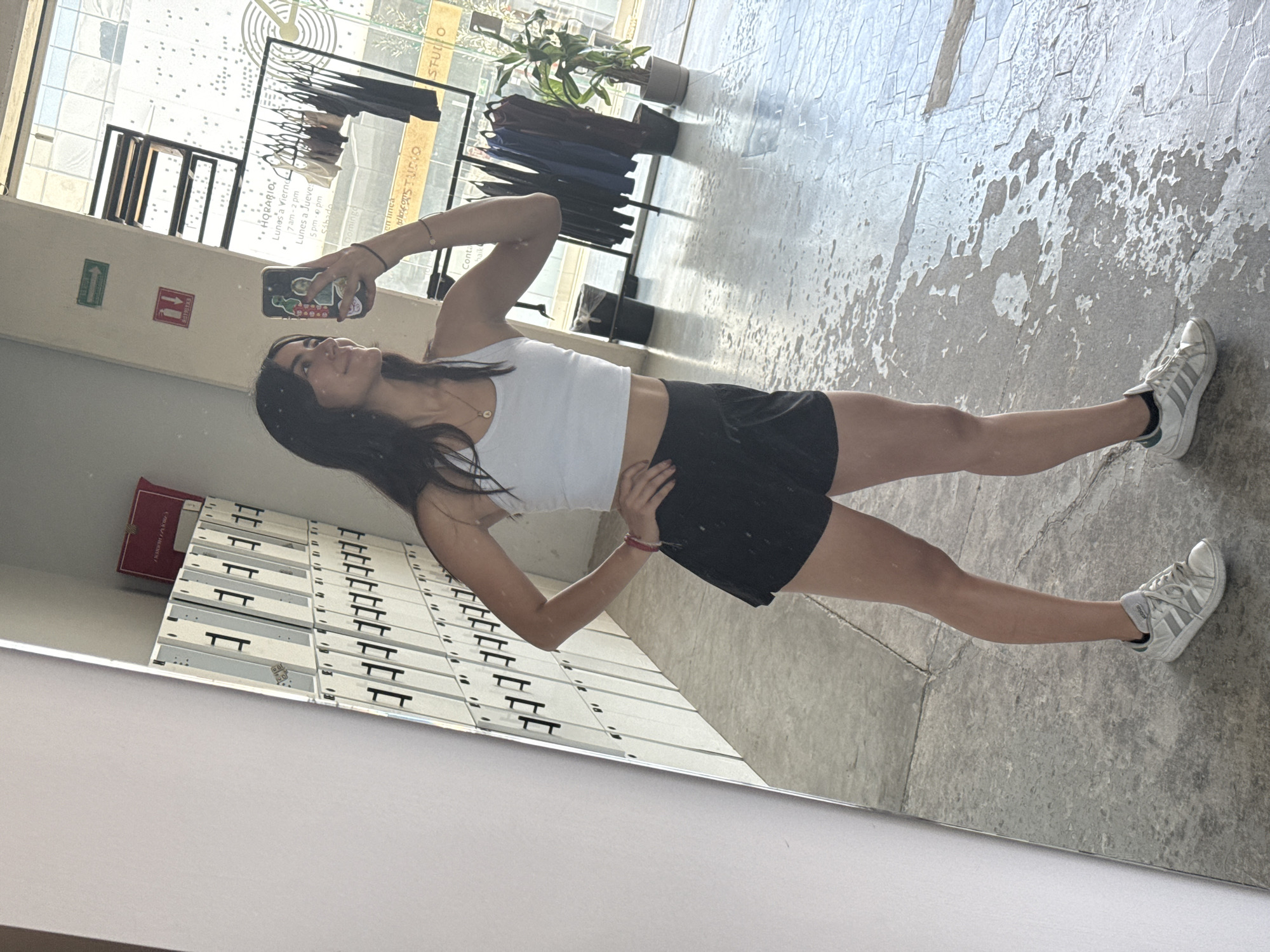 Woman takes mirror selfies, uses Apple devices in Puebla studio