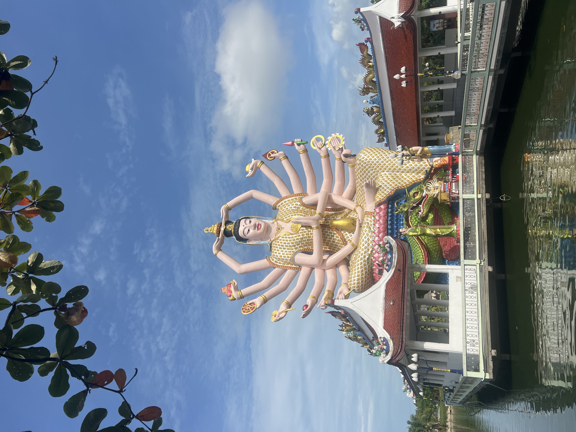 Tourist visits Wat Plai Laem temple, documents statues and wildlife