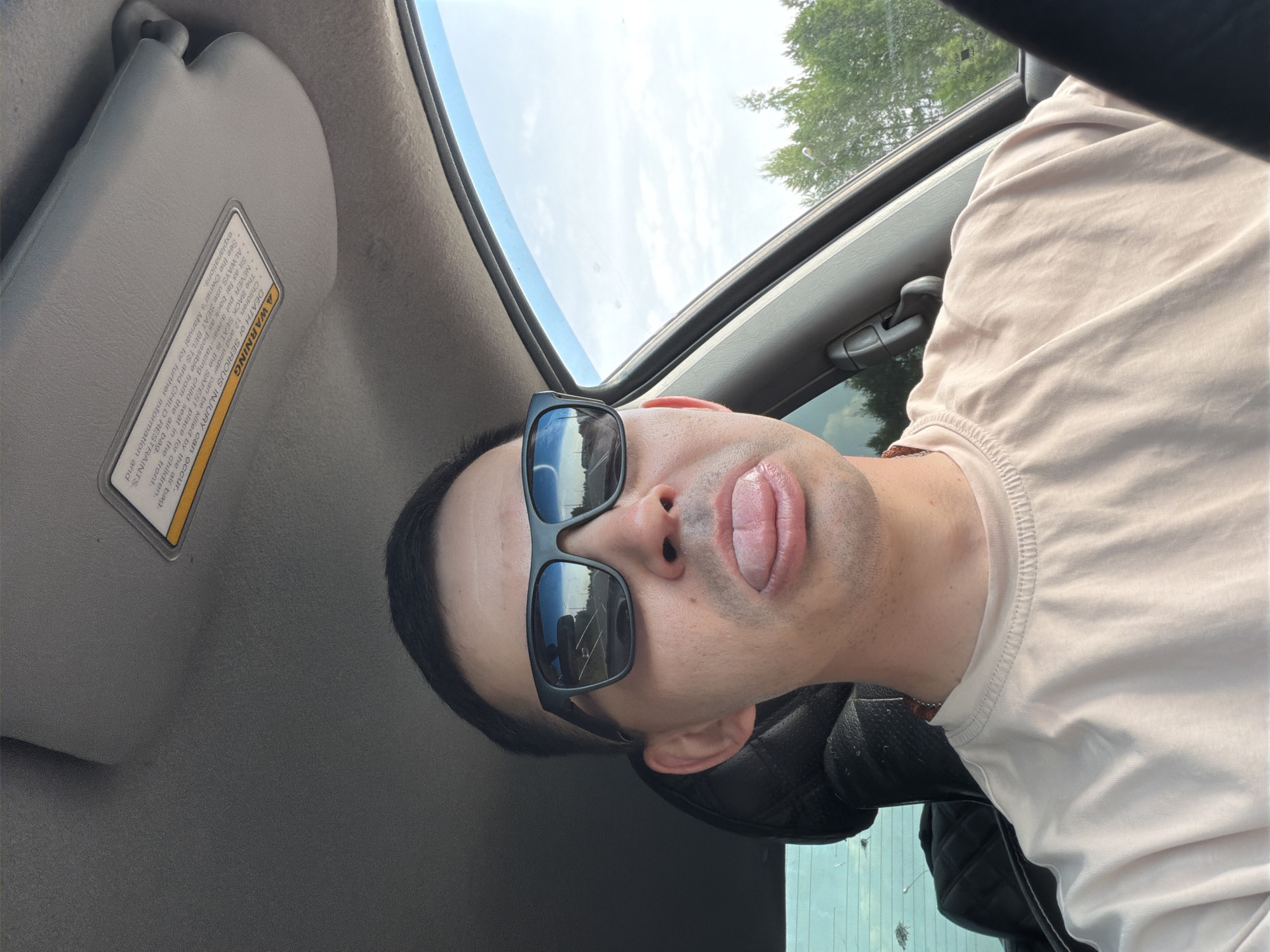 Person in sunglasses photographed in car and street moments apart