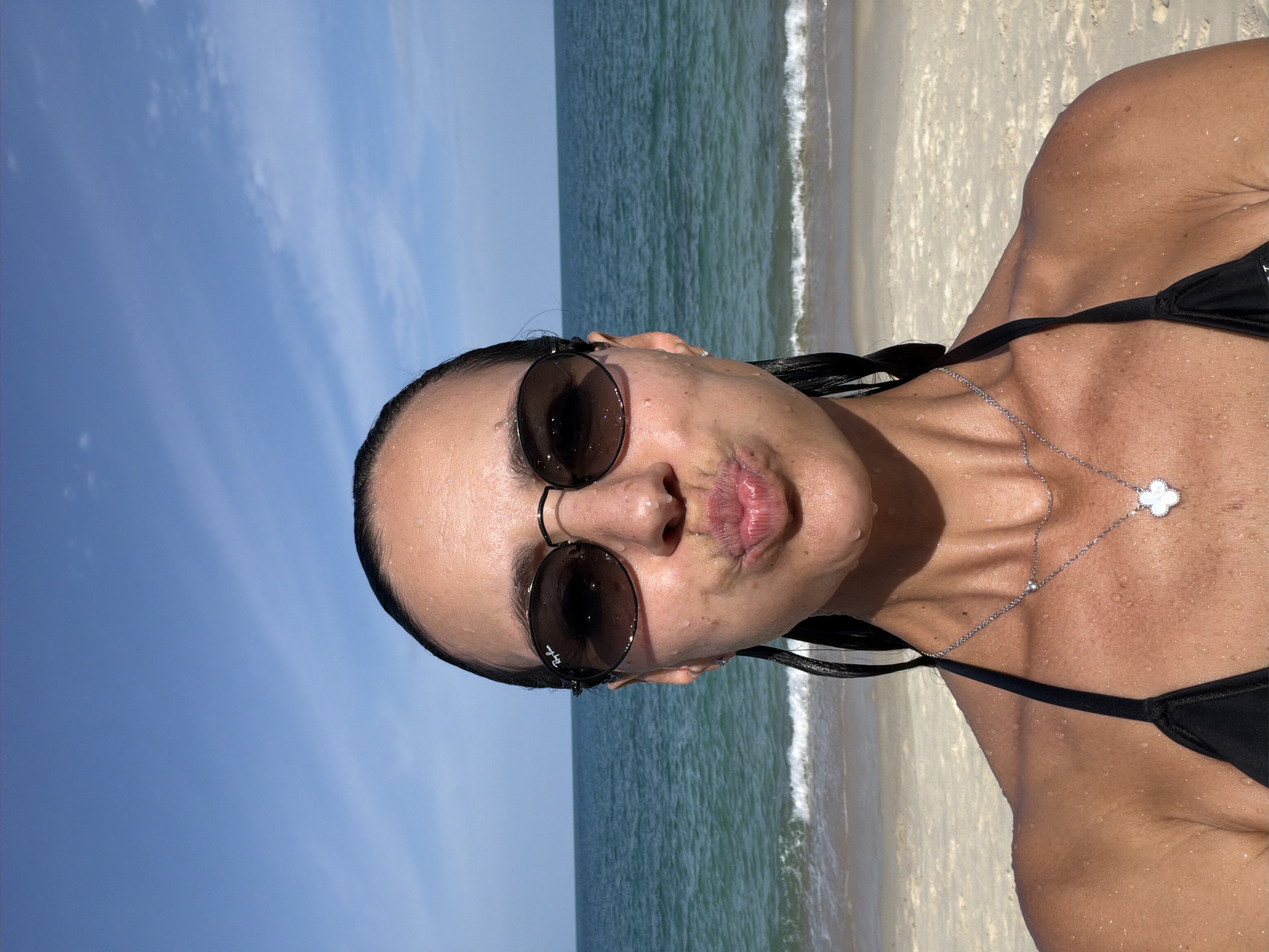 Beachside selfie with ocean backdrop on a sunny day