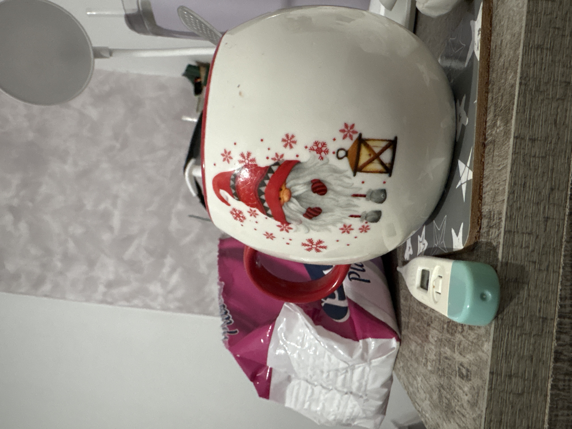 Festive gnome mug photographed with thermometer in Bulgaria