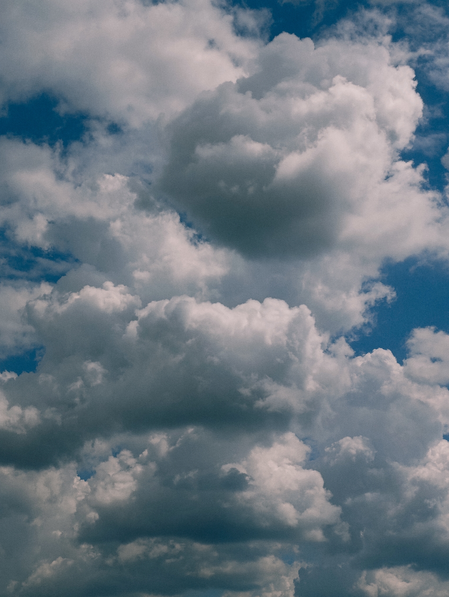 Dramatic cloud formations photographed from below, building in frame
