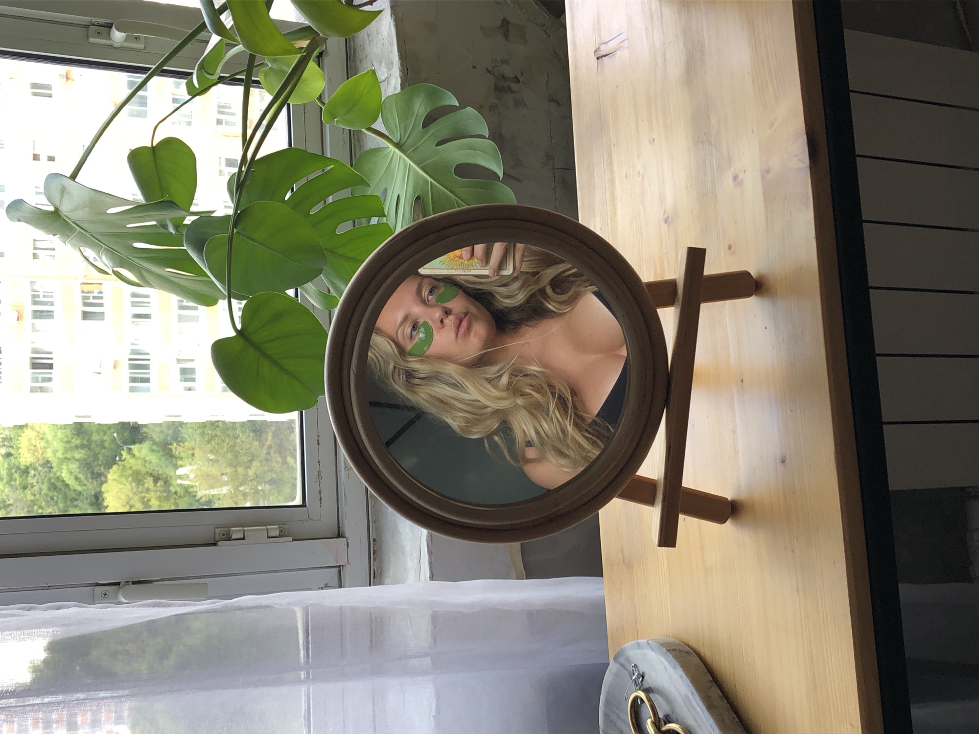 Mirror selfie with under-eye patches, Khimki home setting