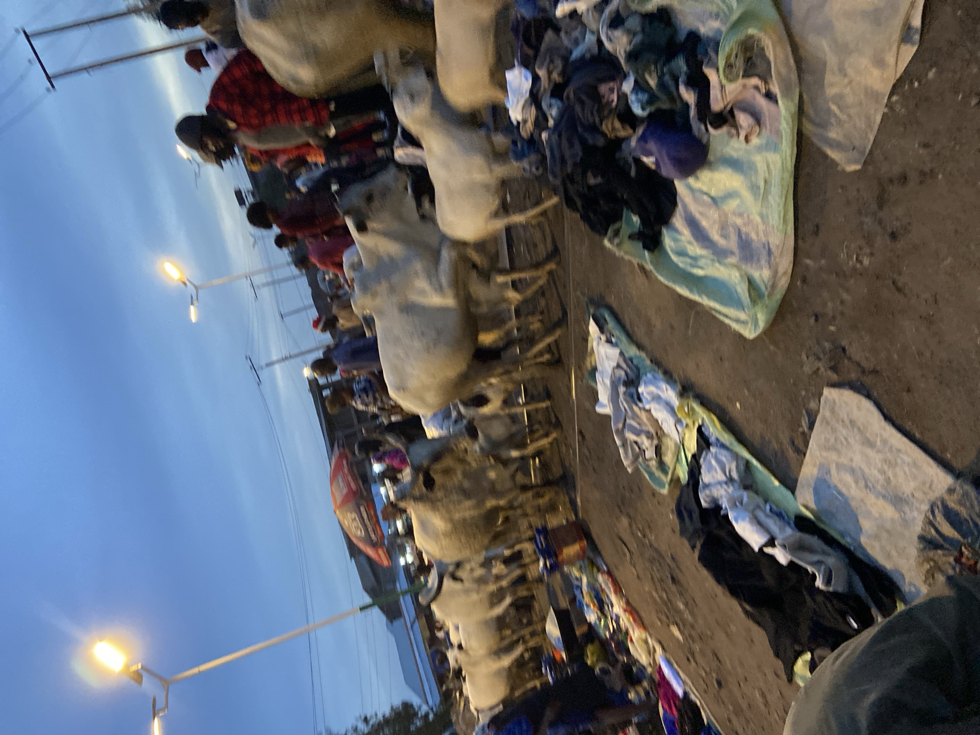 Bukuru street market at dusk, vendors and traffic in full swing