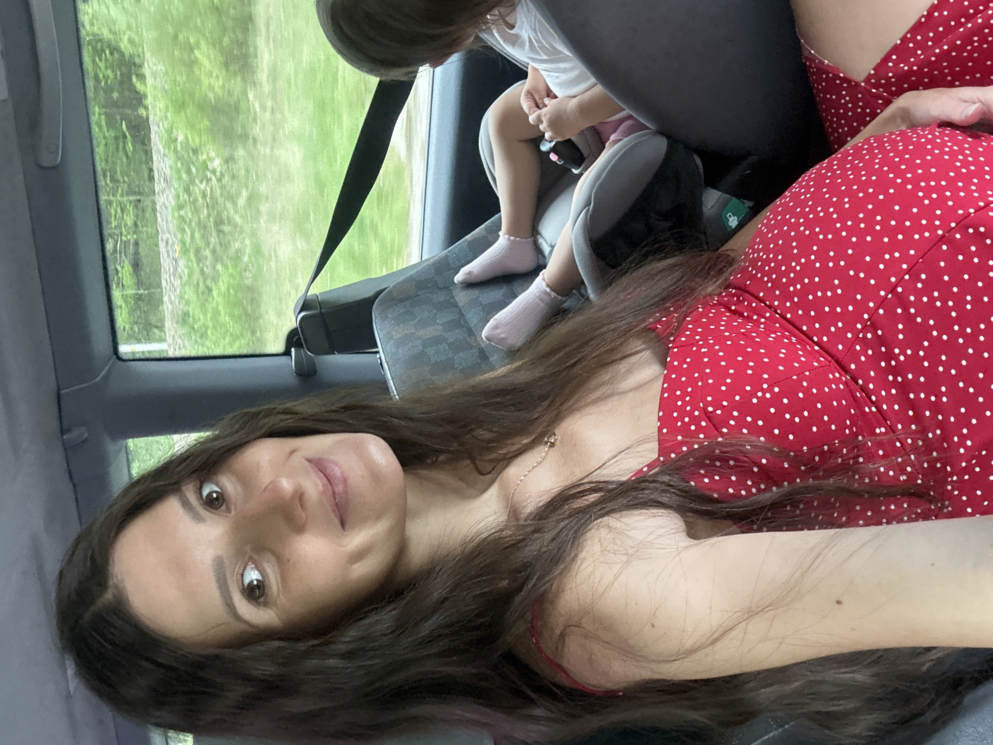 Woman in polka-dot dress photographed inside vehicle in Poland