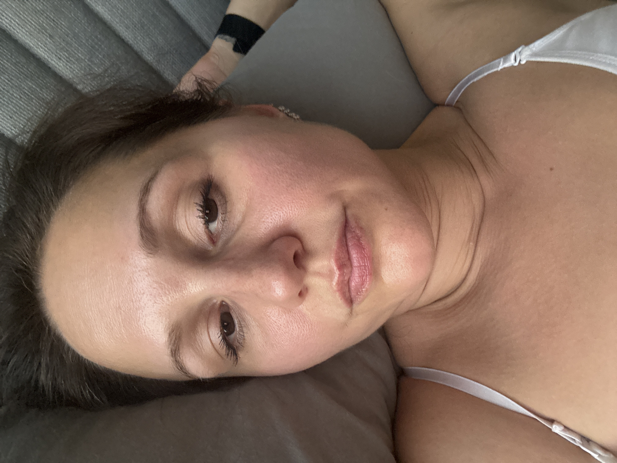 Woman rests on grey cushioning in Dubai