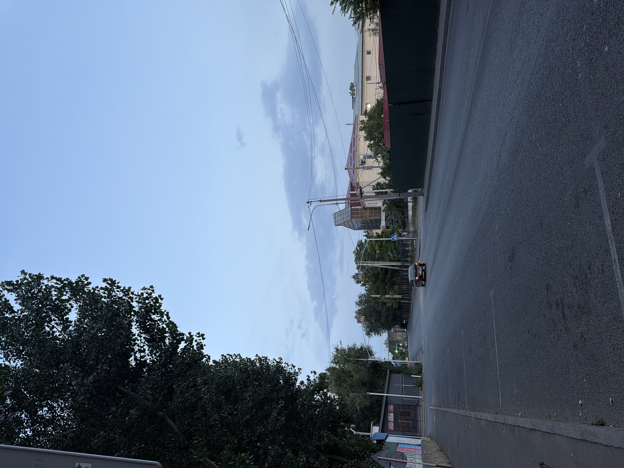 Evening street scene along a Shymkent road