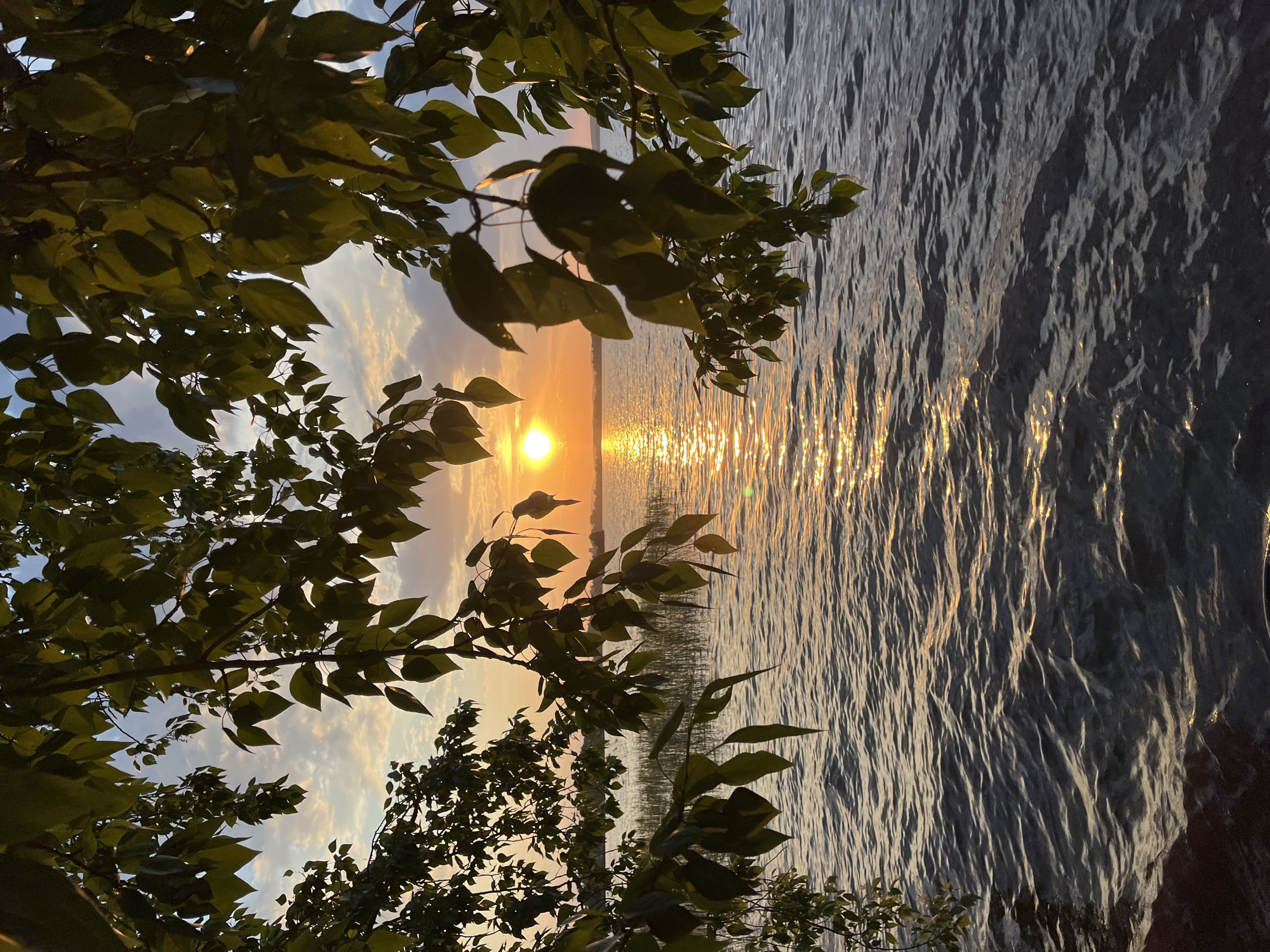 Two people watch sunset over water near Yekaterinburg
