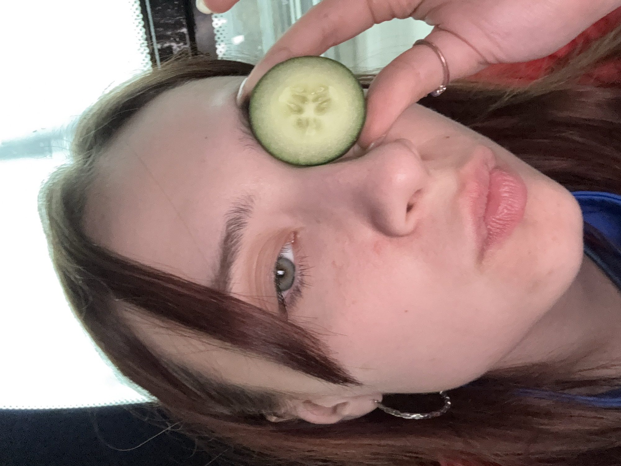 Woman poses with cucumber slice over eye in Yanychi