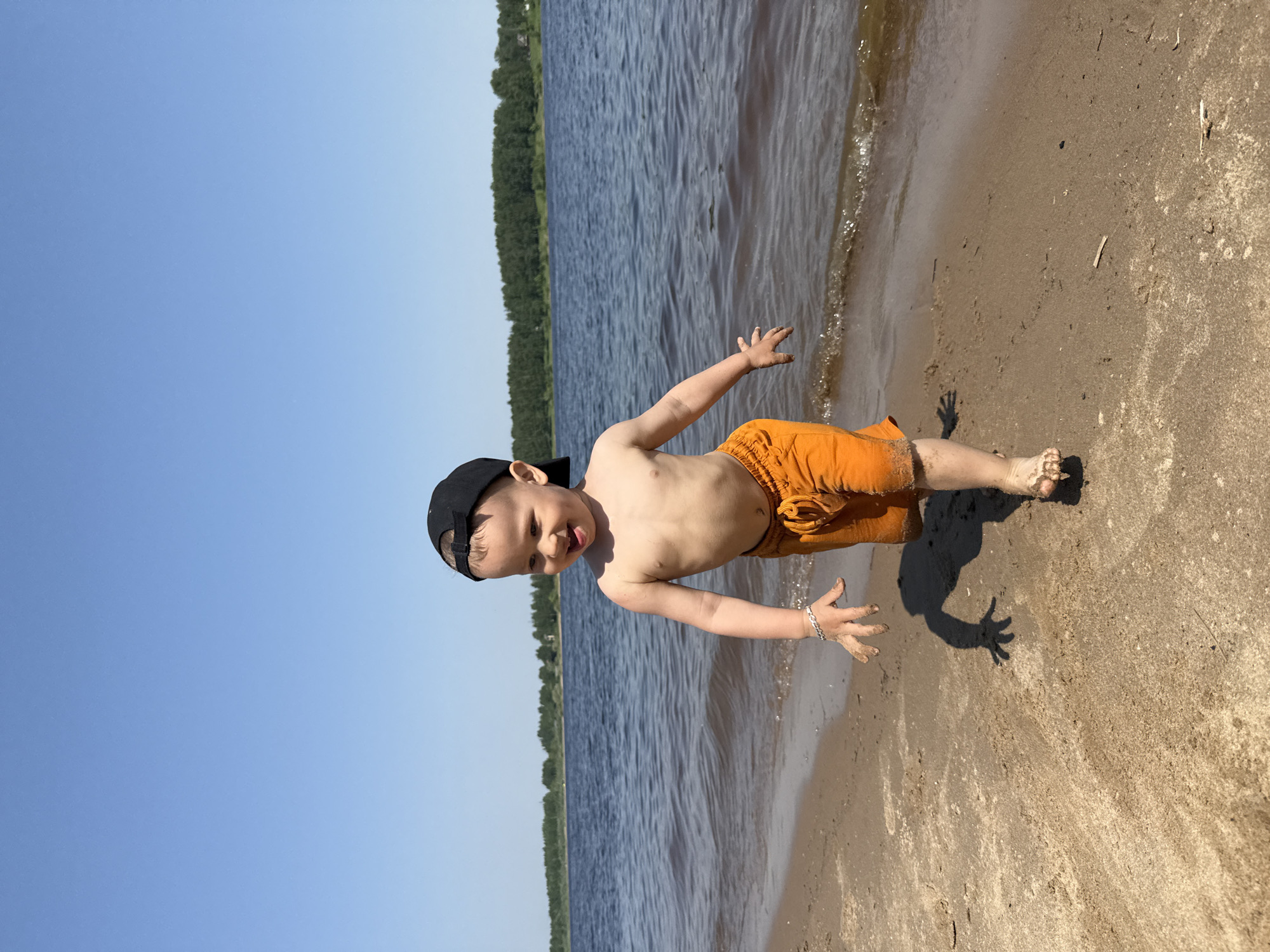 Child plays in sand at Rusanovo beach