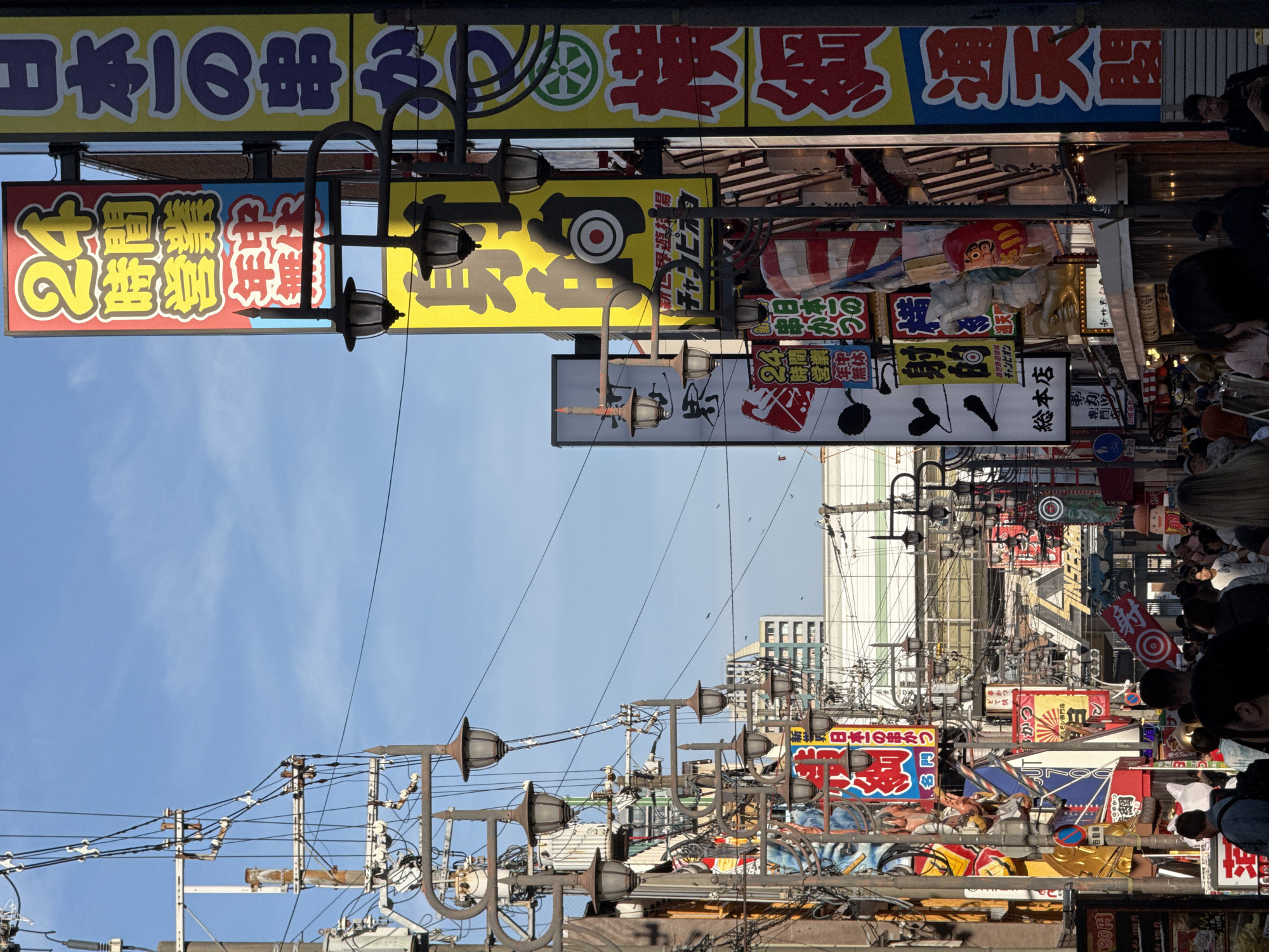 Tourist documents colorful Osaka streetscapes and landmarks during morning walk