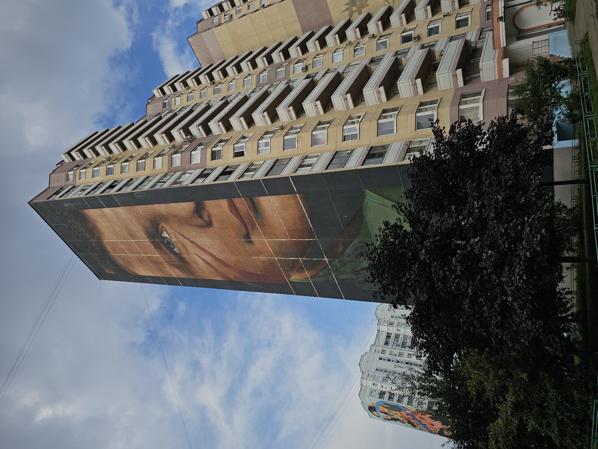 Large-scale murals cover the side of an Odintsovo apartment block