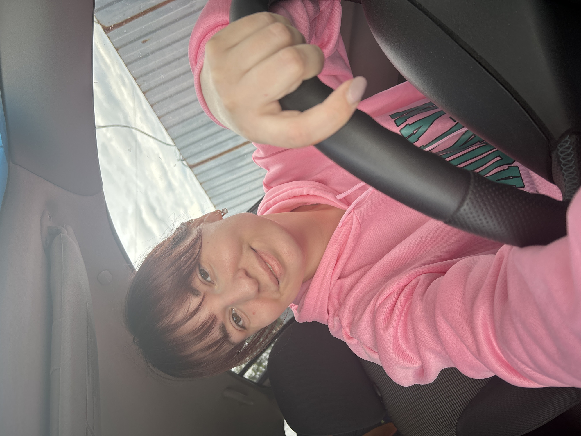Woman in pink hoodie takes selfies with child in Russia