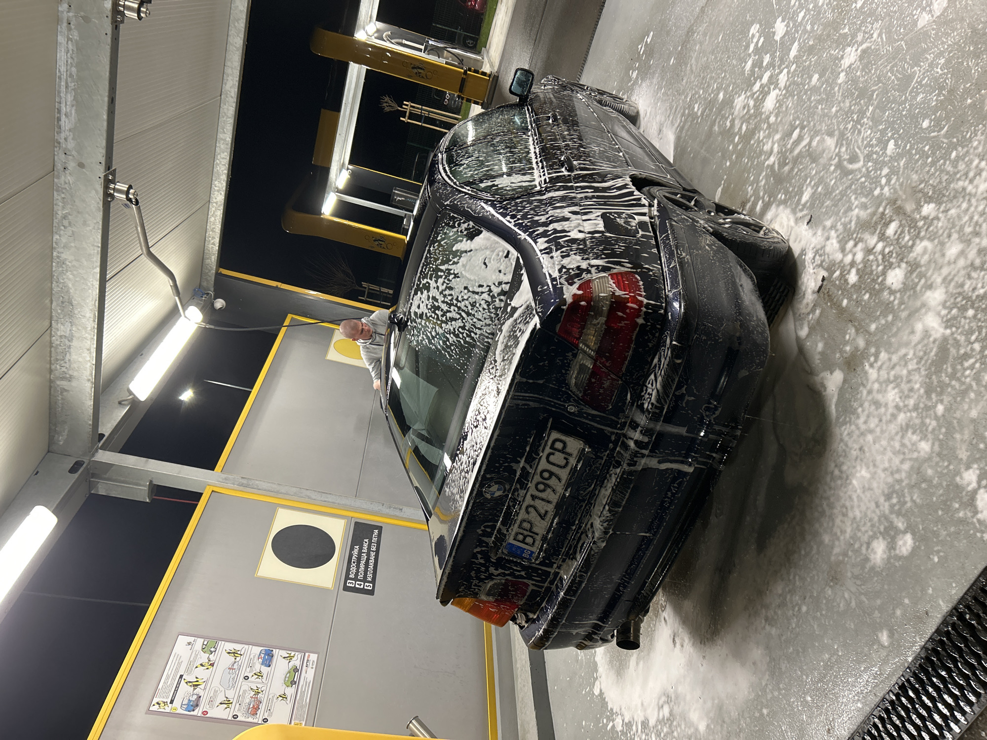 BMW sedan gets washed at self-service car wash