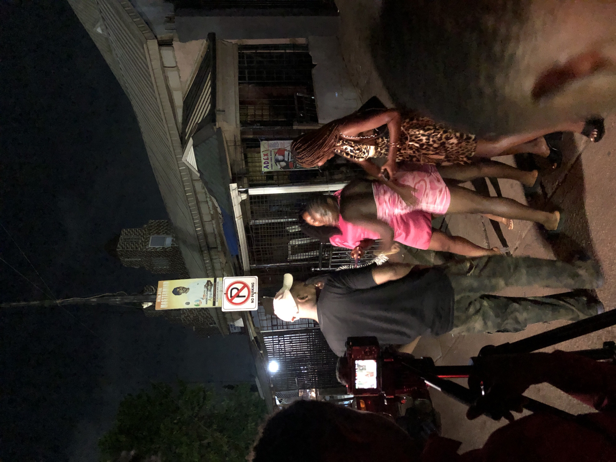 Four women filmed by camera crews on urban street