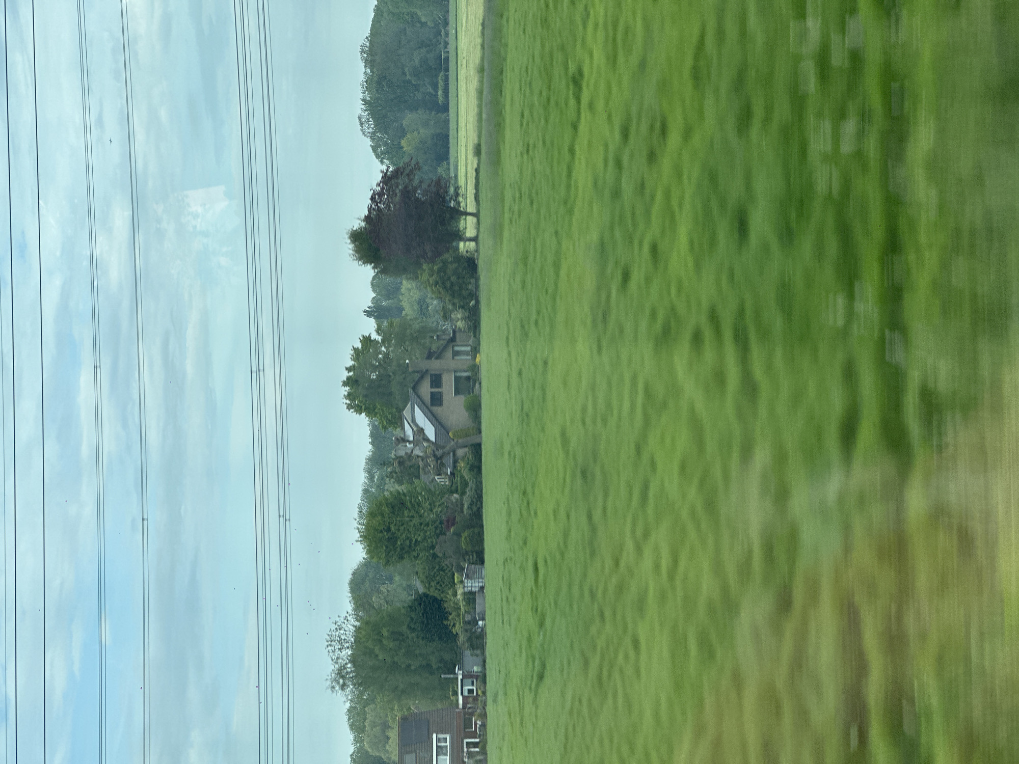 Train passenger views Dutch countryside near Loenersloot