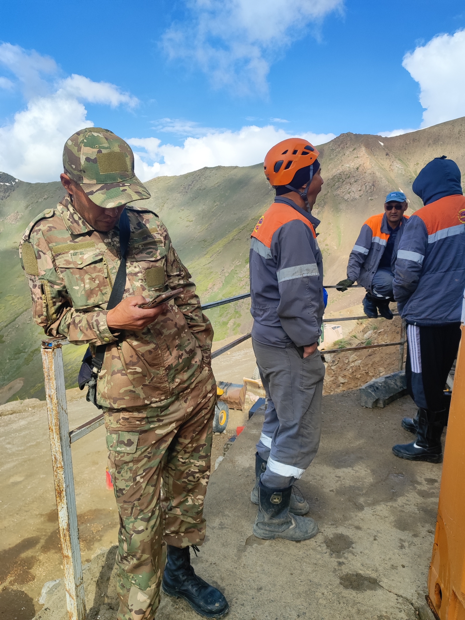 Construction activity and ground inspection in remote Kyrgyzstan mountains