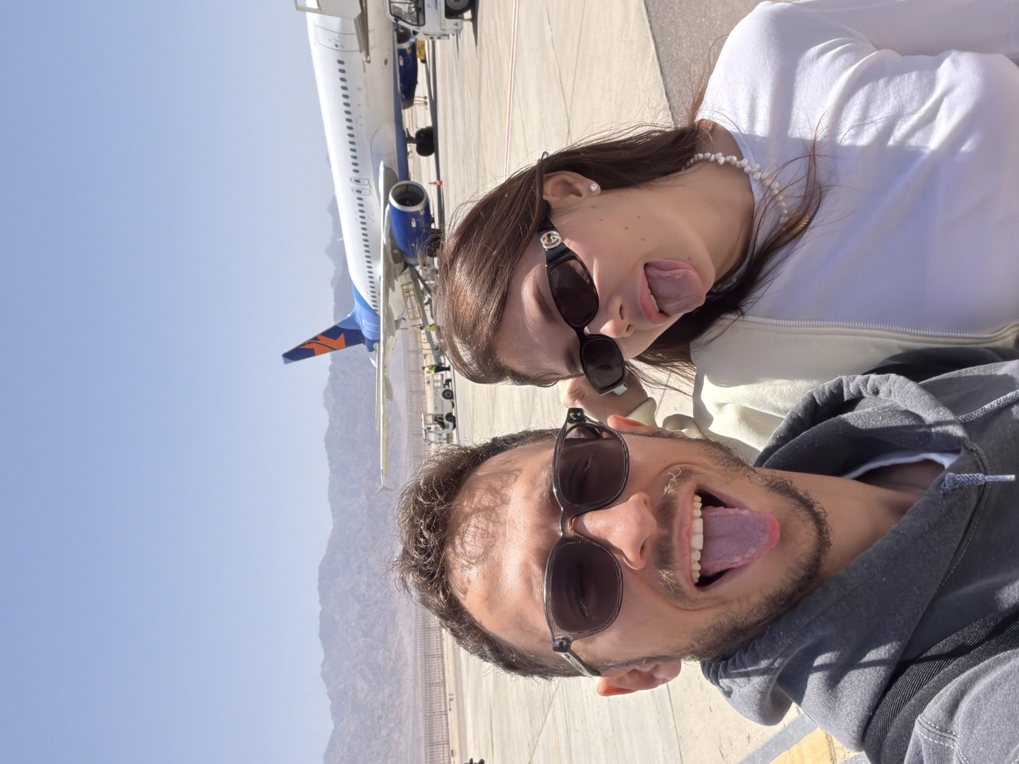 Tourists take selfies on Eilat airport tarmac