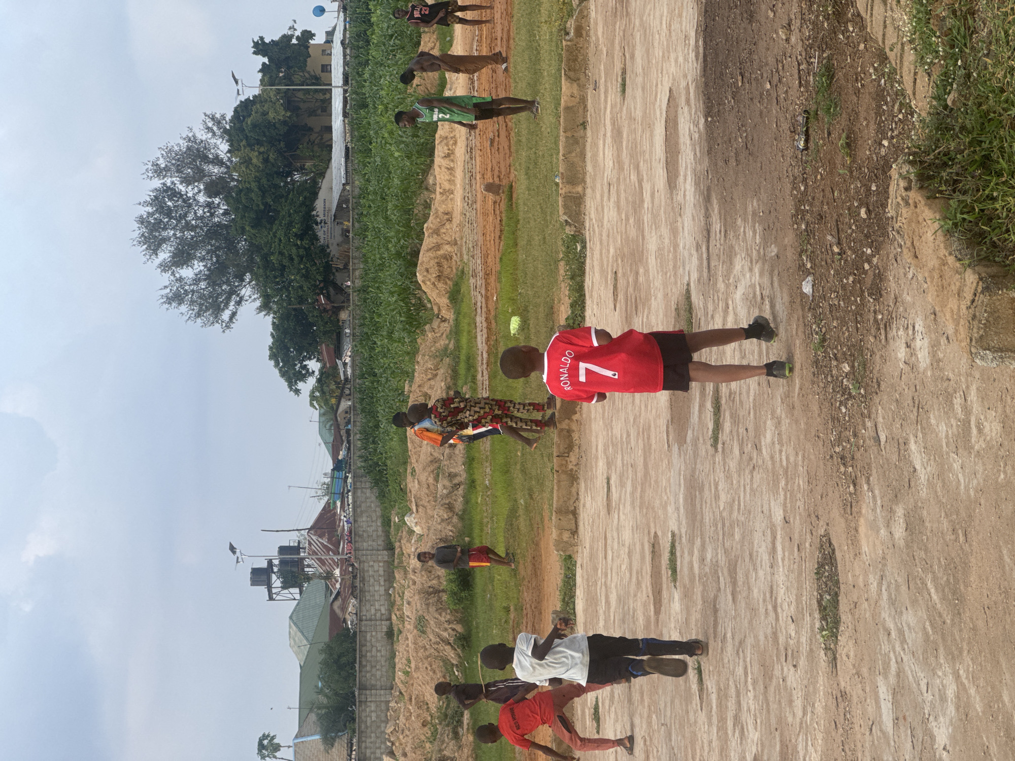 Pickup soccer game on a dirt field in Karum, Nigeria