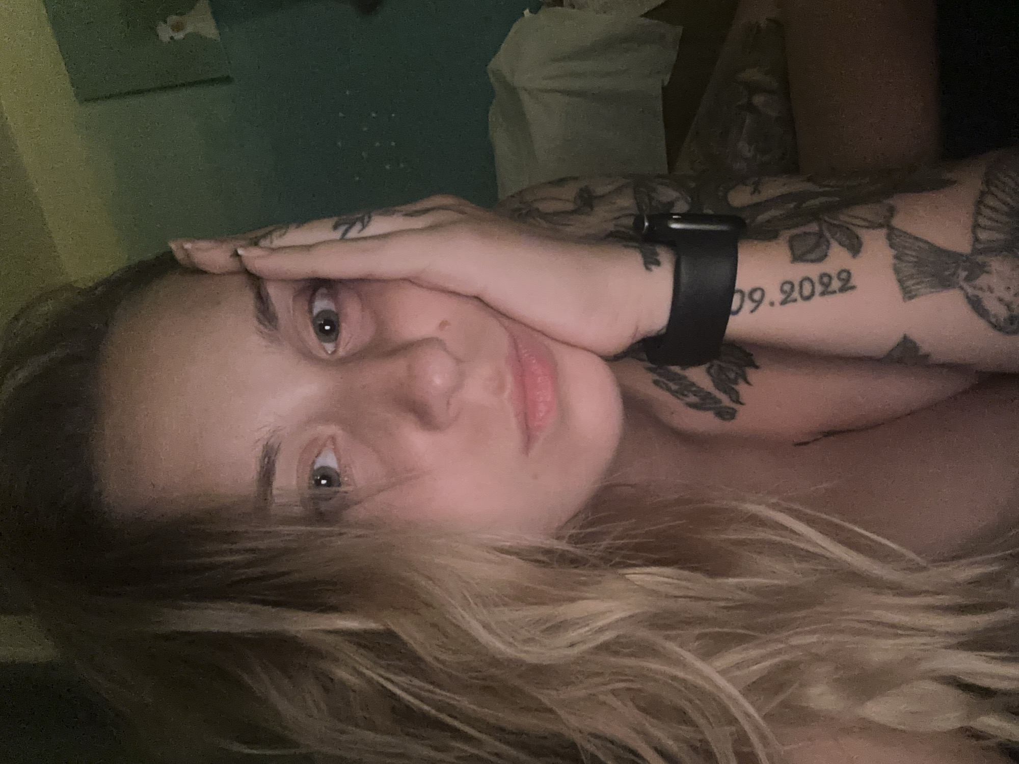 Quiet moment in a decorated Plovdiv bedroom, tattoos in focus