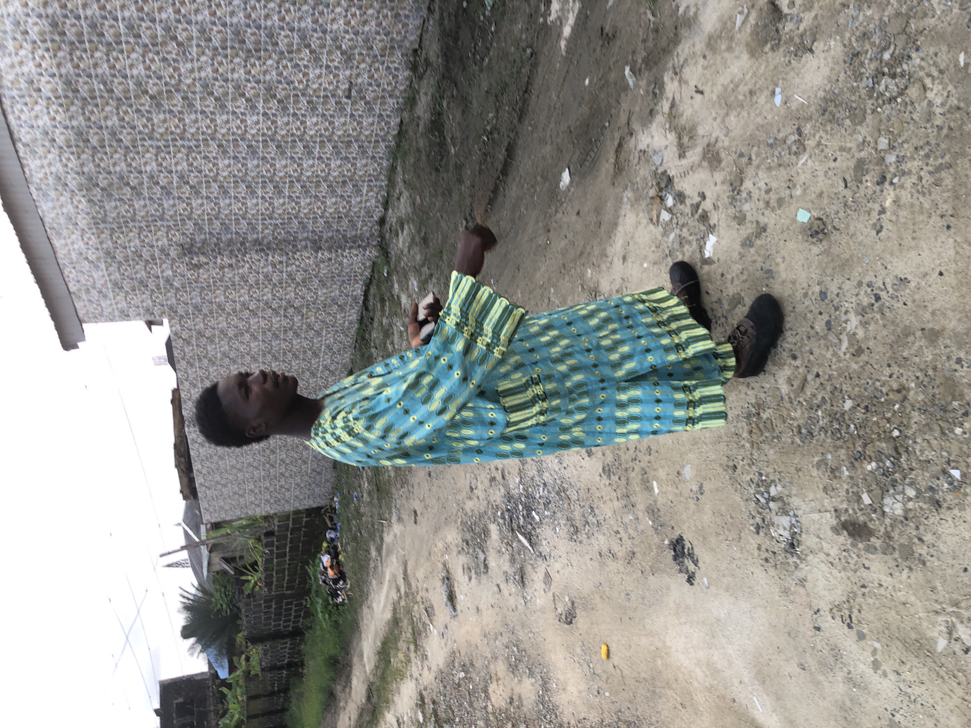 Street scenes in Ado, Nigeria, at sunset along a dusty road
