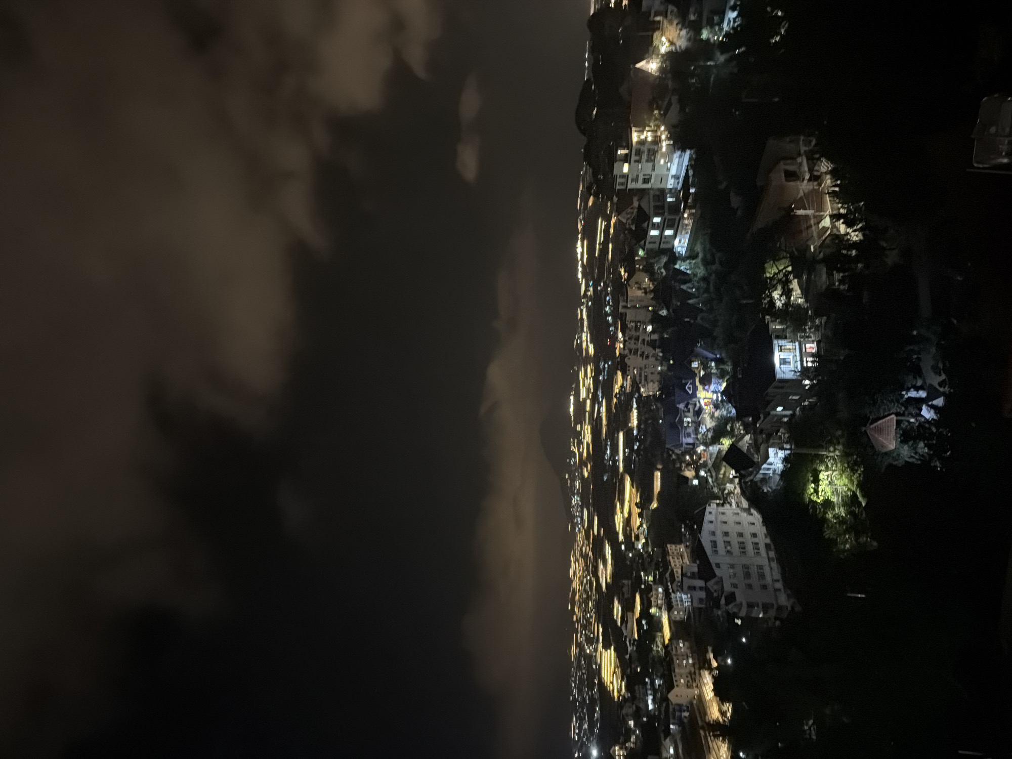 Nighttime aerial views capture illuminated Đà Lạt cityscape with greenhouses