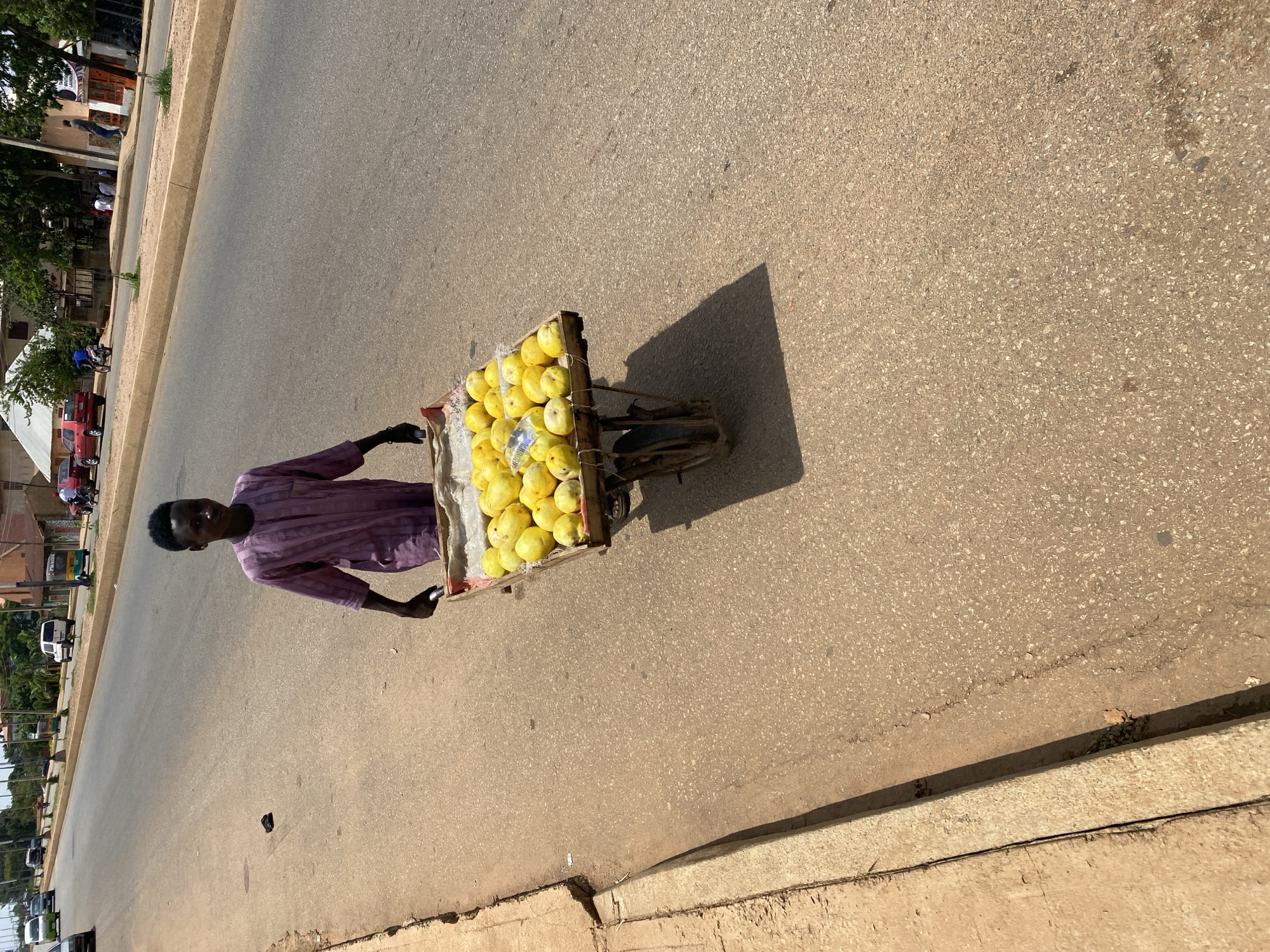 Street vendors and traders carry goods in Bukuru Nigeria
