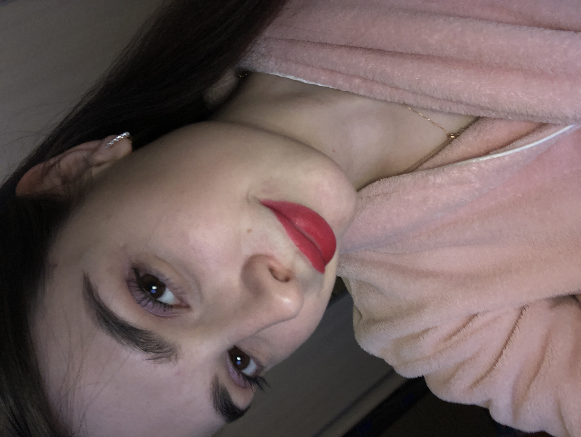 Woman takes indoor selfies in pink bathrobe in Russia