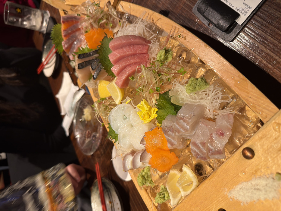 Chef serves sashimi boat platter to family in Shibuya restaurant
