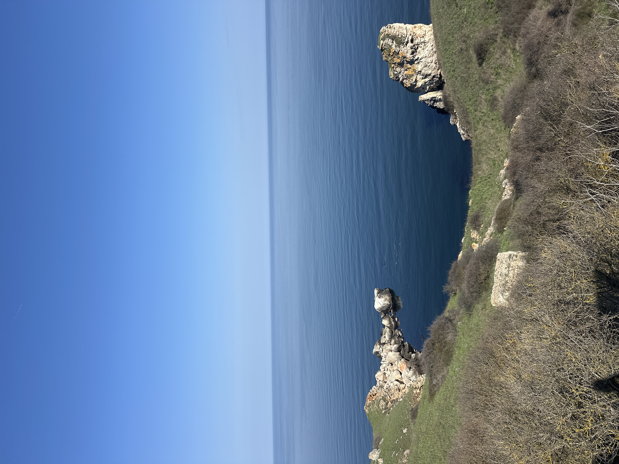 Visitor documents scenic Black Sea cliffs at Kamen Bryag