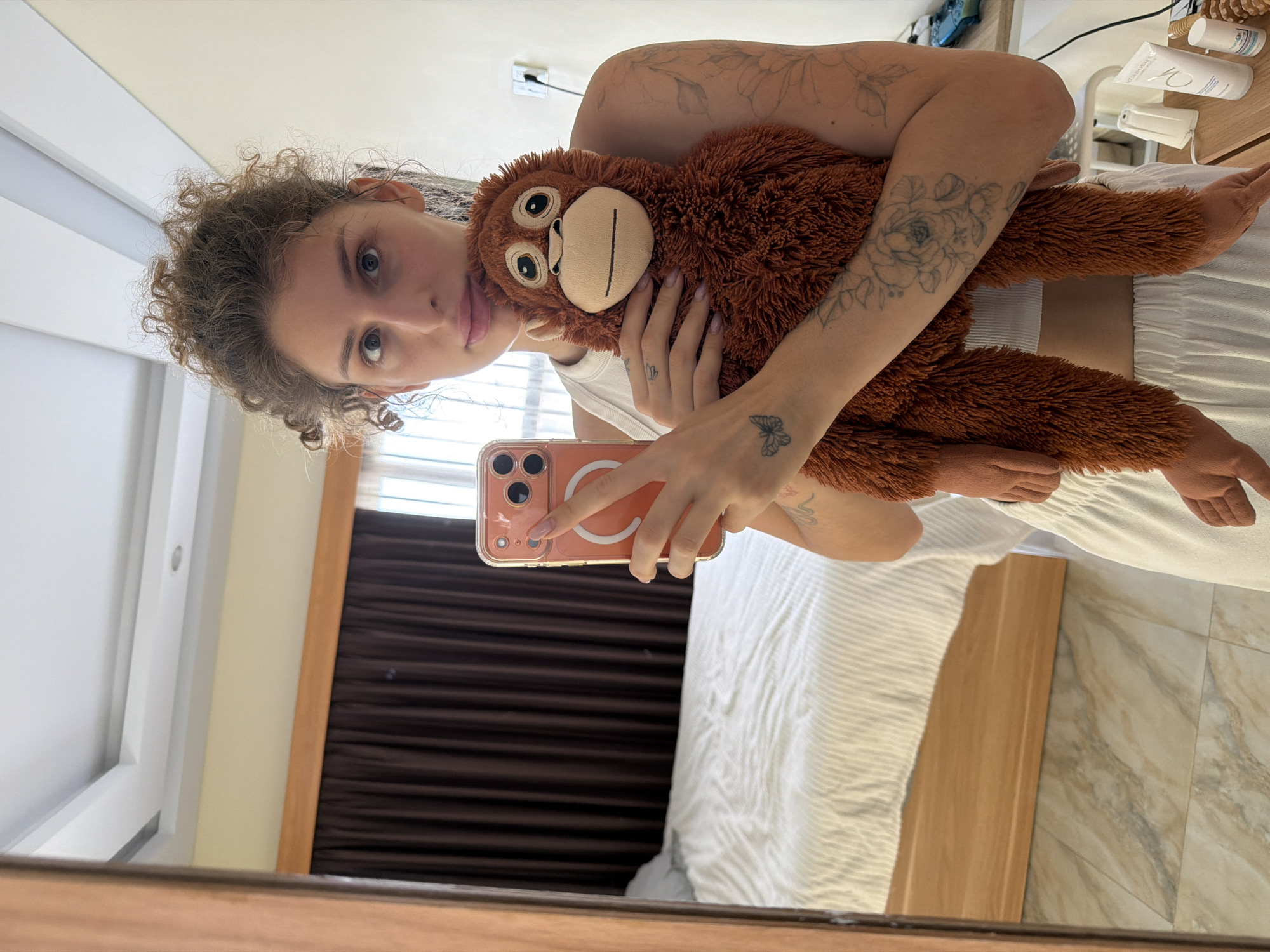 Hotel room outfit shots in Bali with a stuffed orangutan