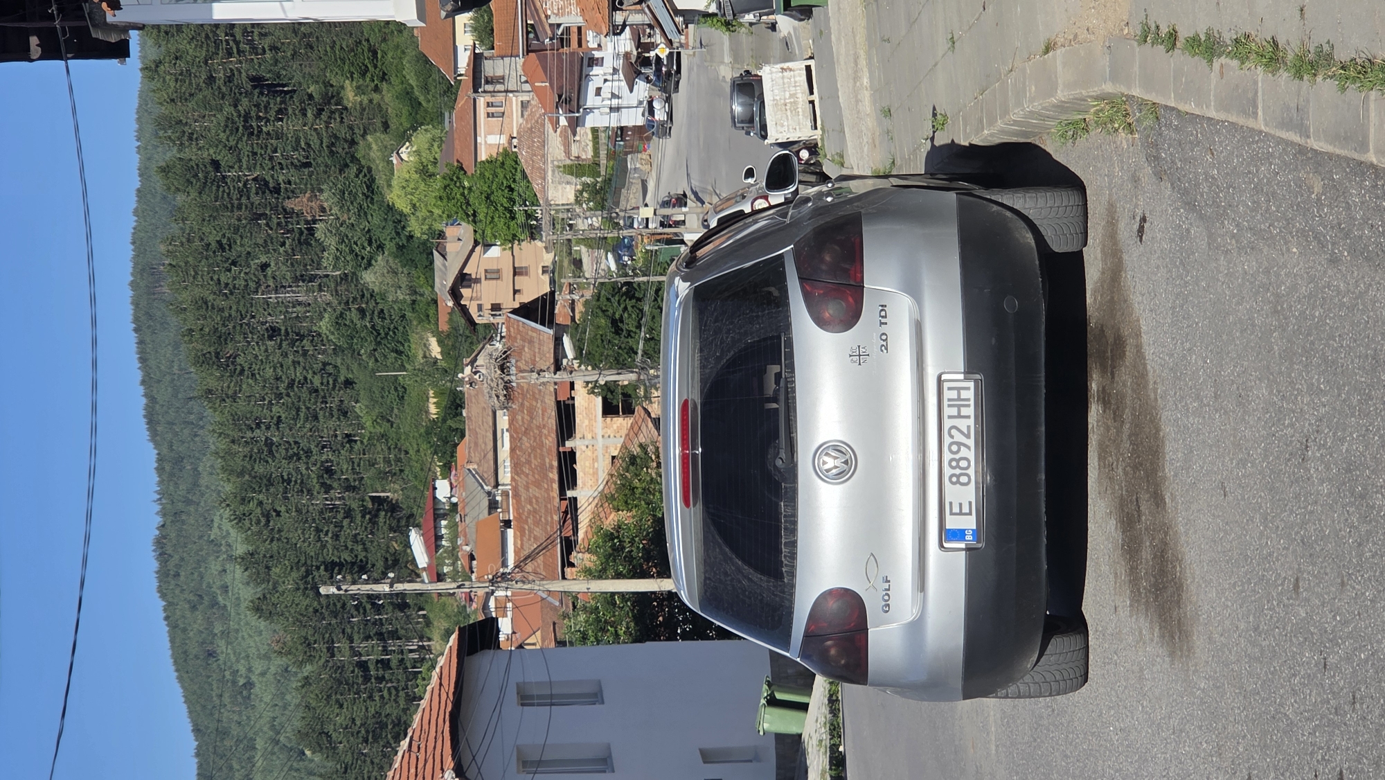 Silver VW Golf parked on a street in Bania, Bulgaria
