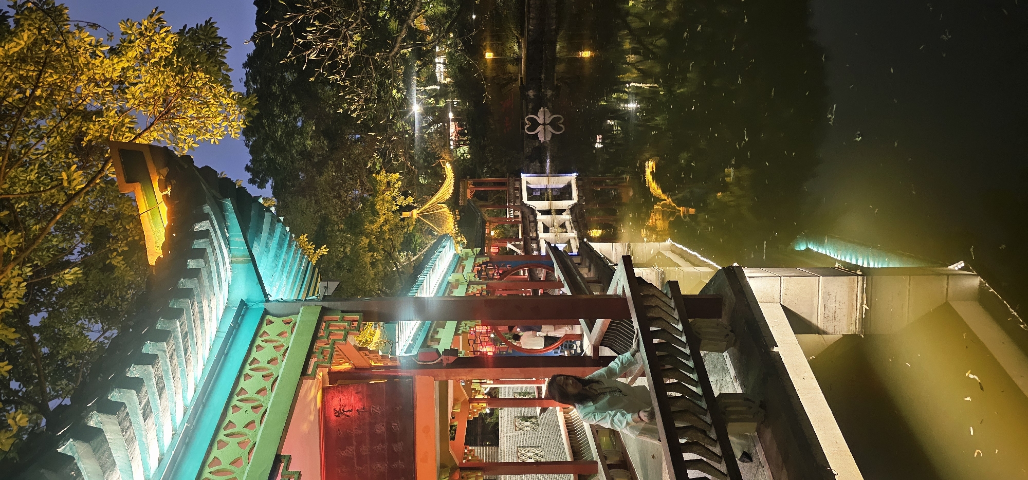 Evening stroll captured on illuminated traditional walkway in Chongqing