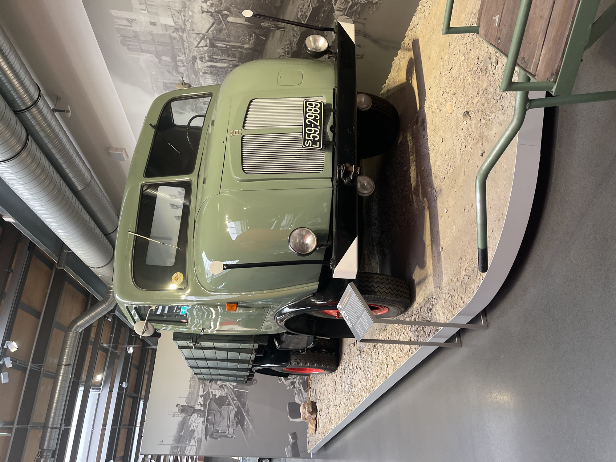 Vintage vehicles and automotive artifacts on display at a museum