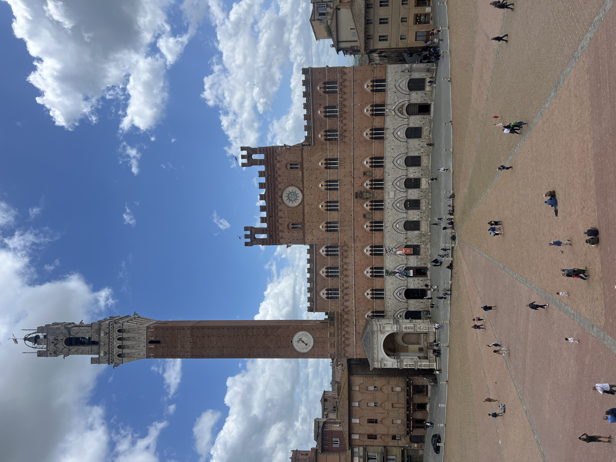 Morning street life documented across historic Siena city center