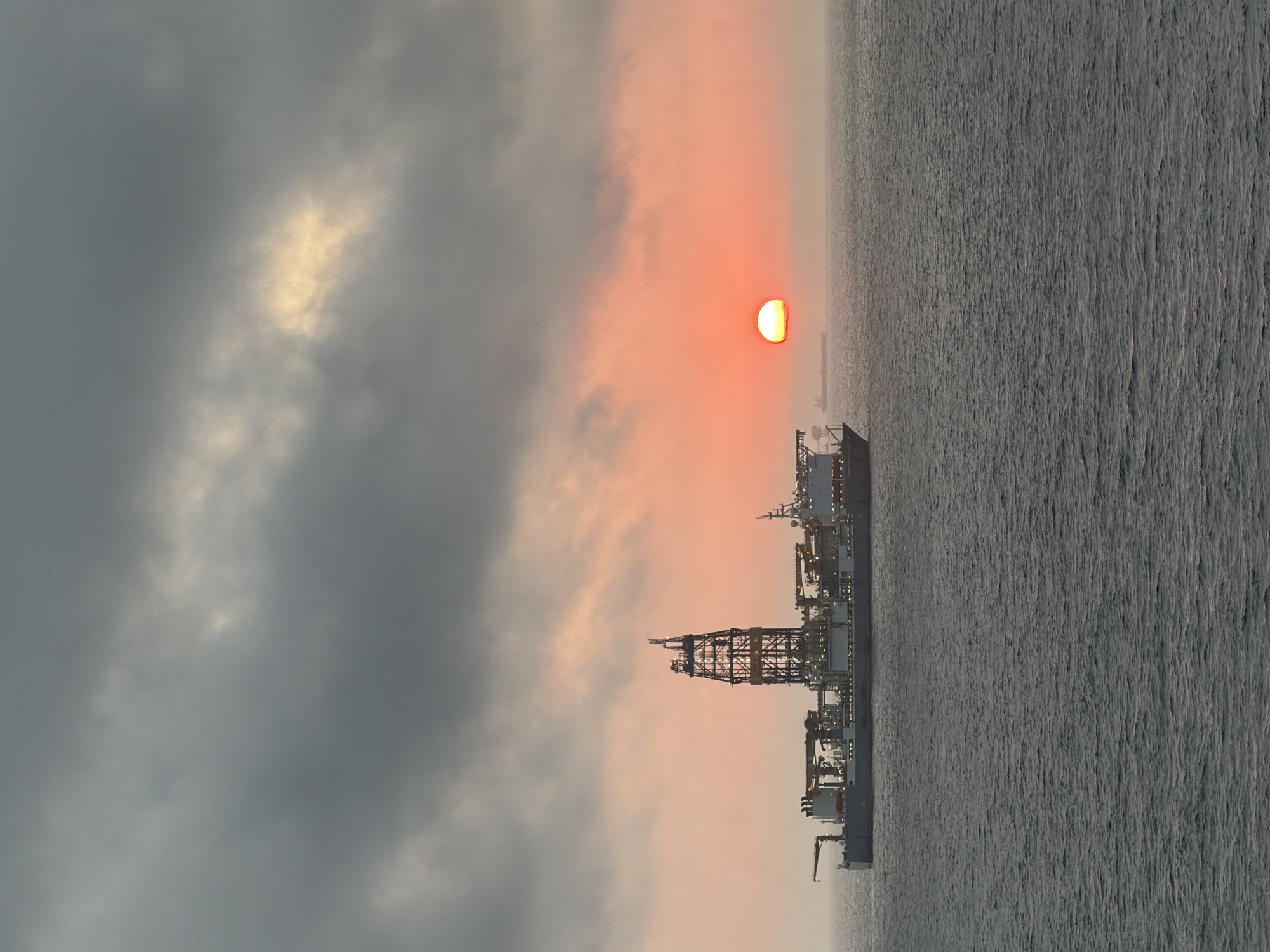 Offshore oil rigs observed during dramatic sunrise in Gulf